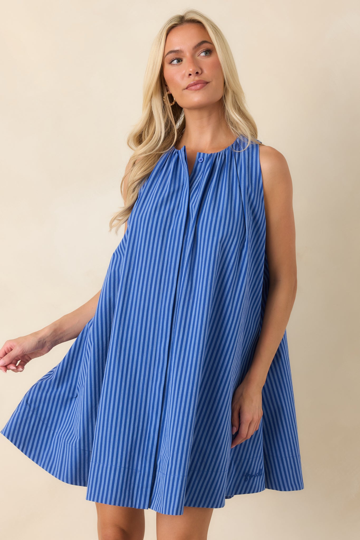 Vertical striped mini dress featuring a comfortable fit, breathable fabric, and easy swing shape.