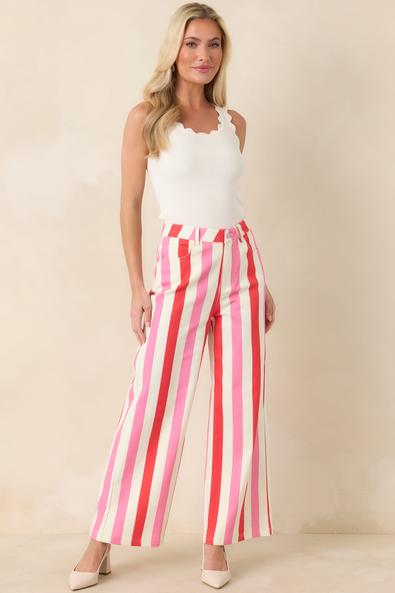 Vertical striped pants featuring functional front pockets, belt loops, and a polished wide-leg fit.