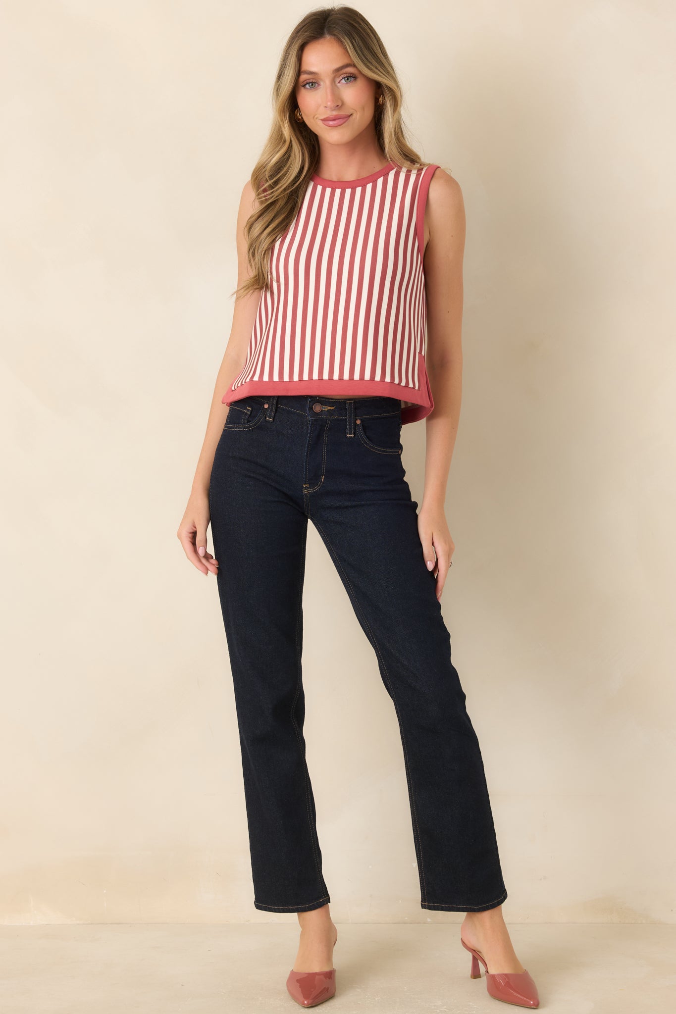 Vertically striped cropped top designed with a simple round neck, sleeveless construction, and terracotta trim for a polished finish.