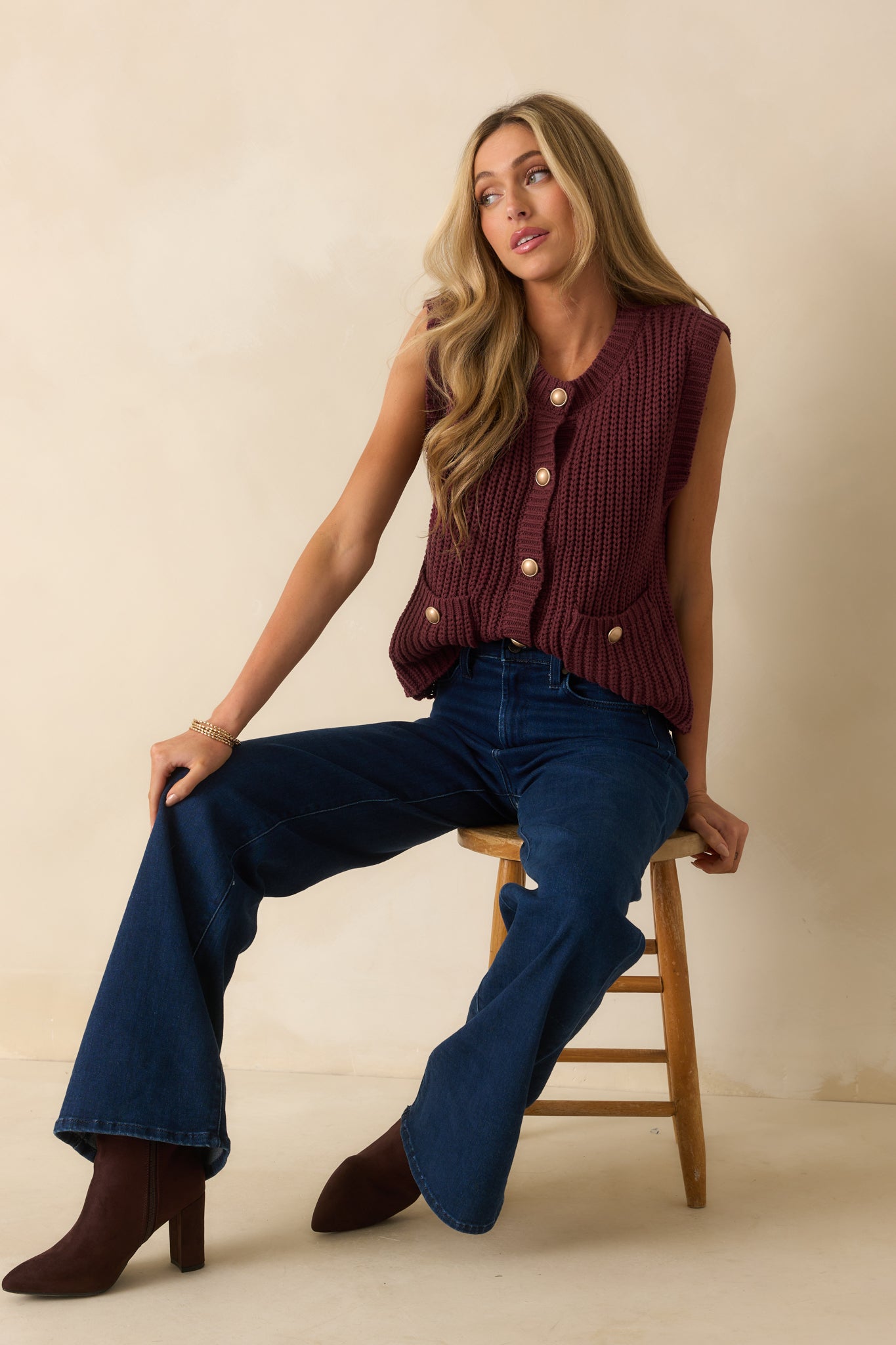 Vest featuring functional front patch pockets and gold-tone domed button closure.