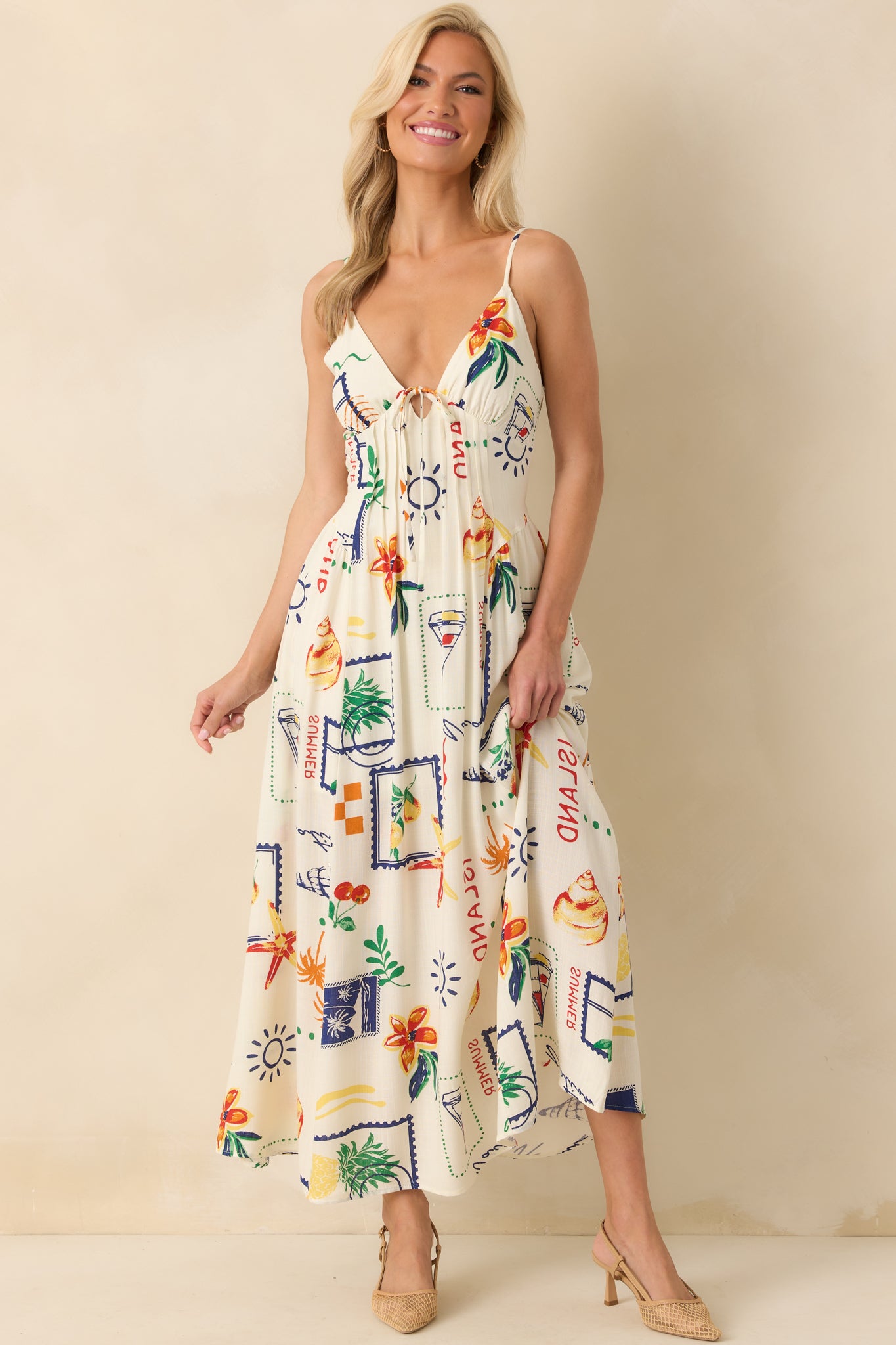 Frontal shot emphasizing the vibrant beach-themed print and the natural drape of the ivory fabric to the ankles.