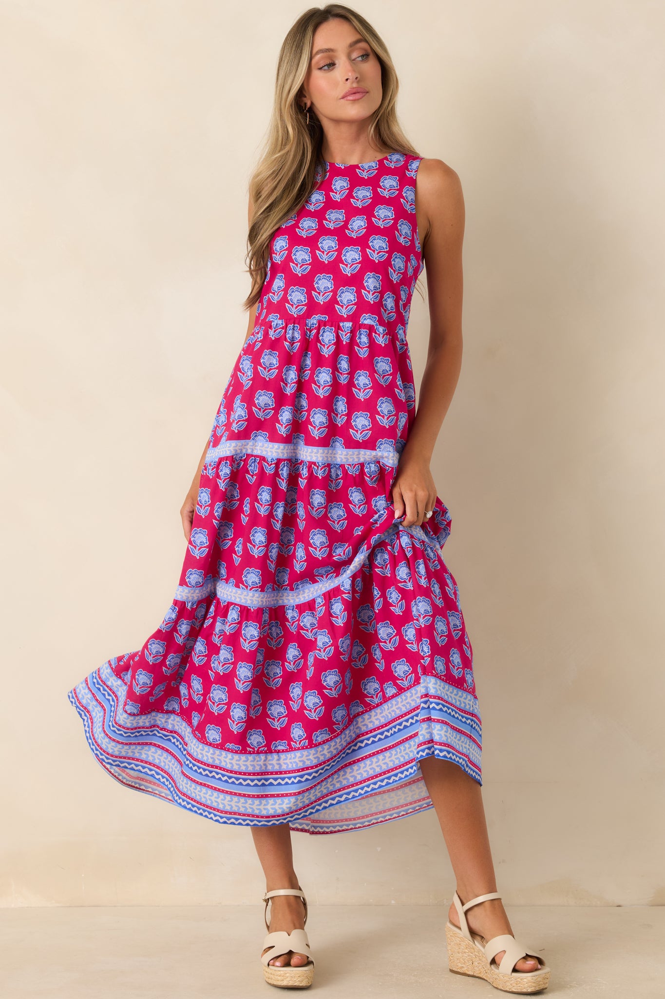 Vibrant floral block print midi dress with a relaxed bodice, flowing skirt, and breathable cotton fabric.