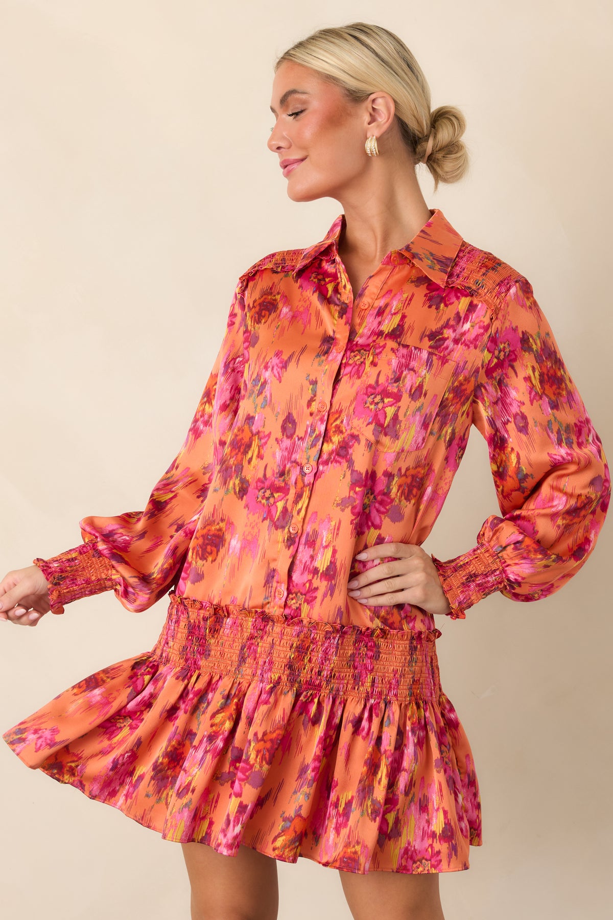Close view of the silky polyester satin fabric highlighting the vibrant floral pattern, relaxed shape, and softly gathered skirt.