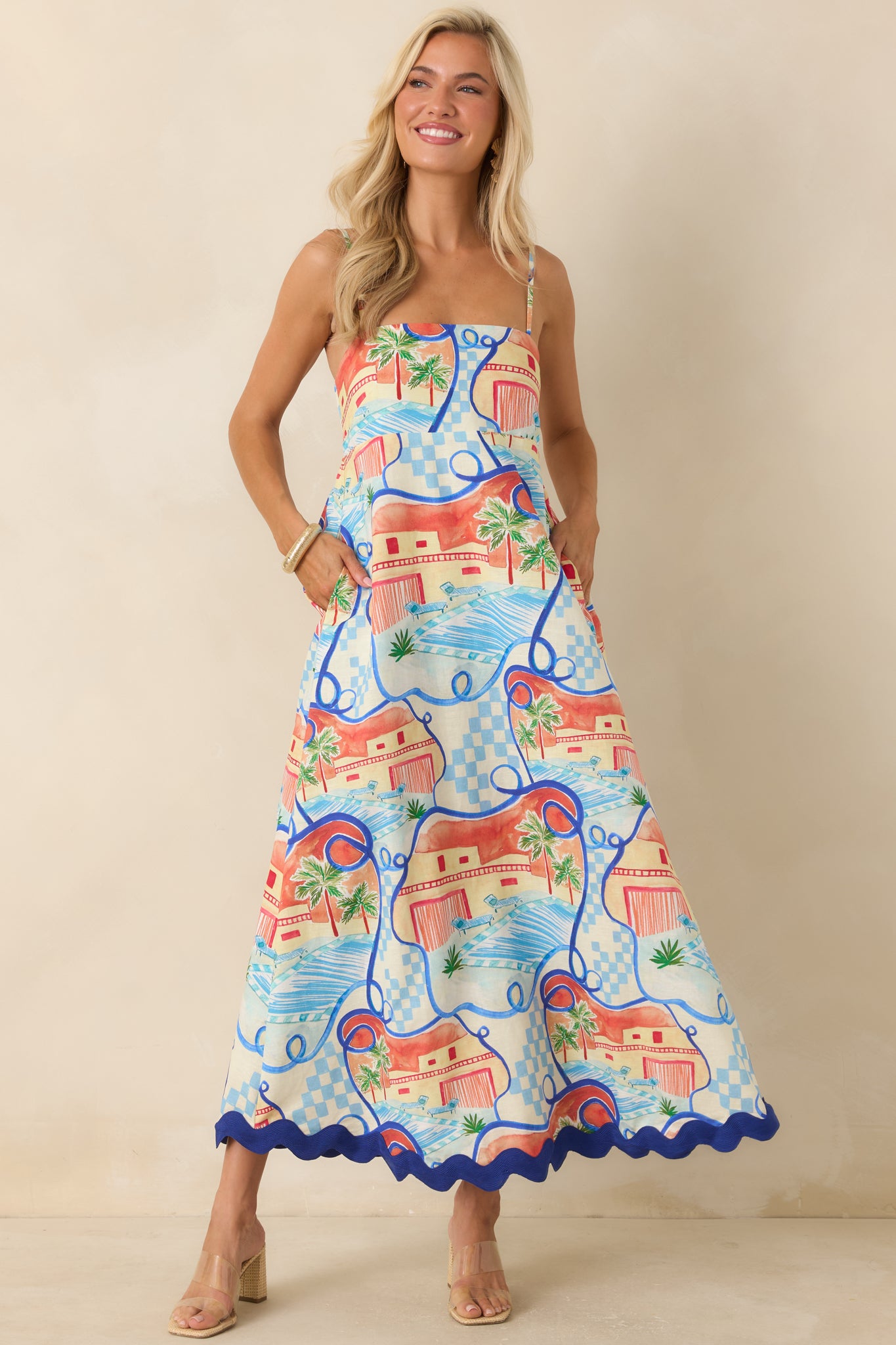 Vacation-ready maxi dress with a vibrant landscape-inspired pattern, adjustable straps, and an effortless floor-length shape.