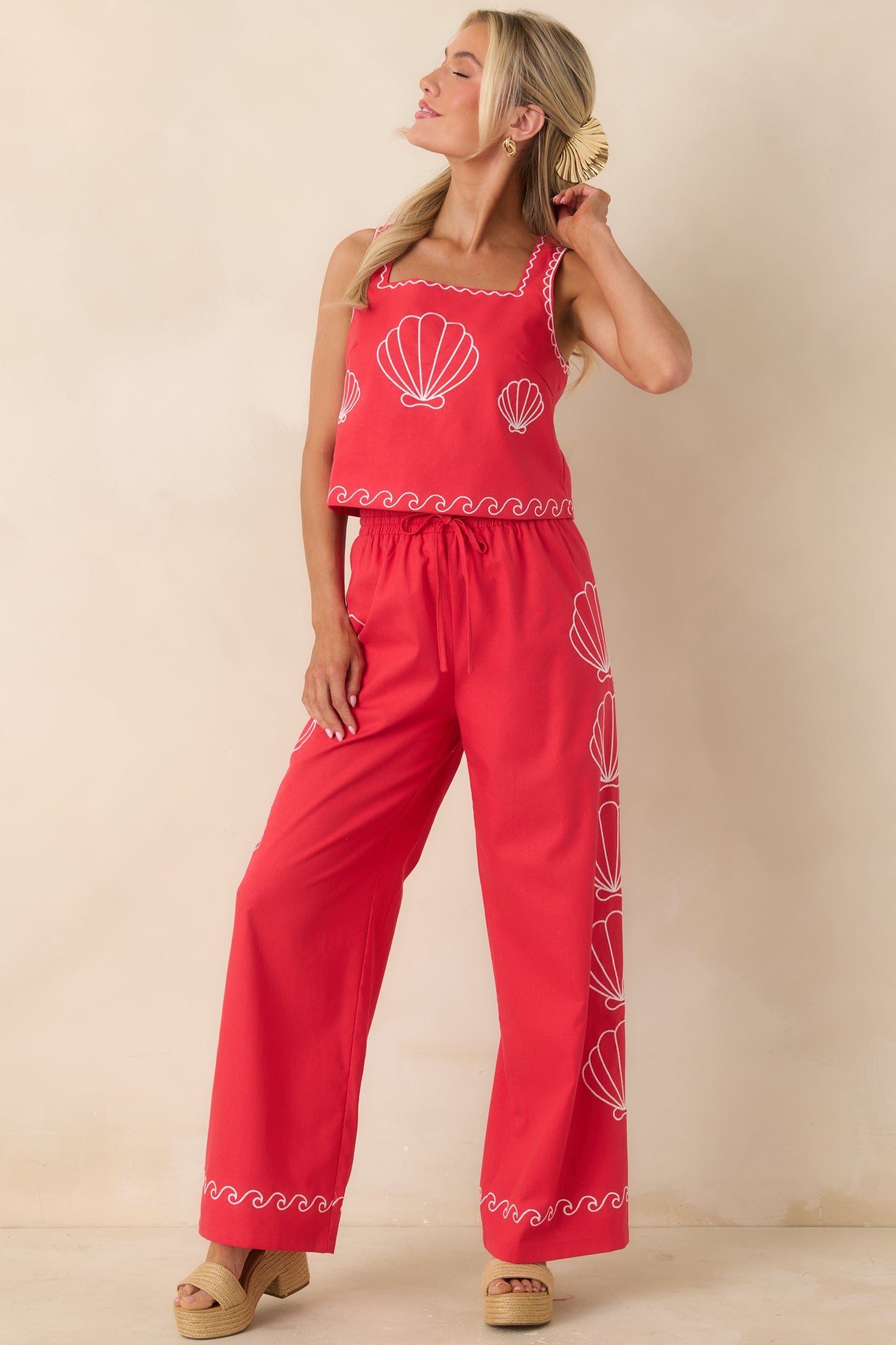 Vibrant red pants with wide leg fit and coastal-inspired embroidered detail.