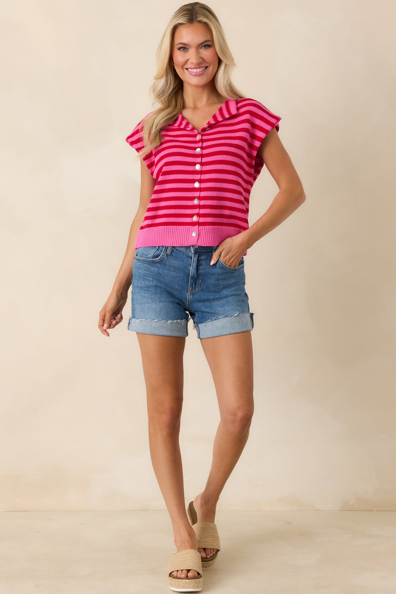 Vibrant striped top with polished collar and full button-front design.