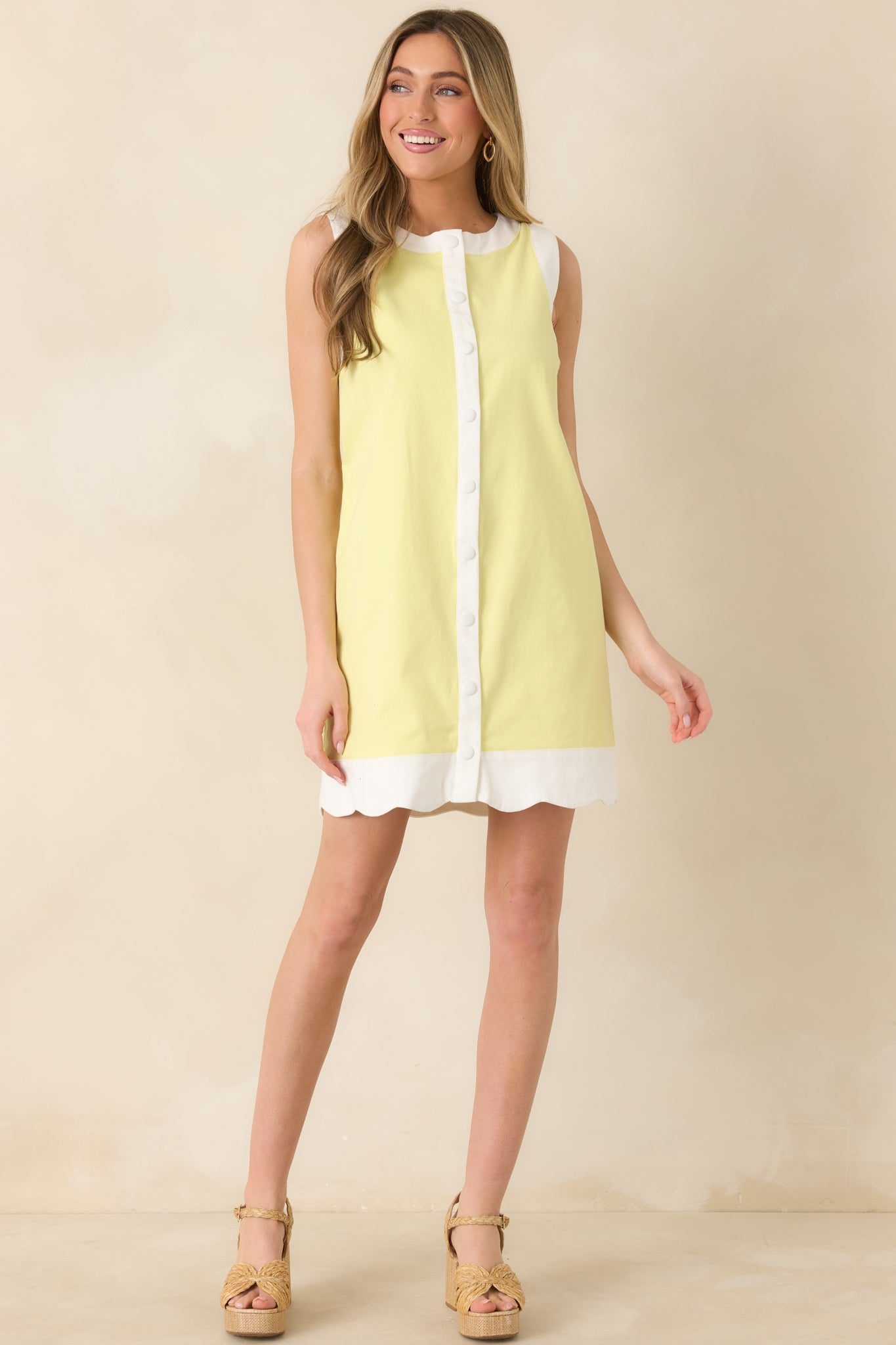 Vibrant yellow dress with easy, relaxed sleeveless silhouette and polished detailing.