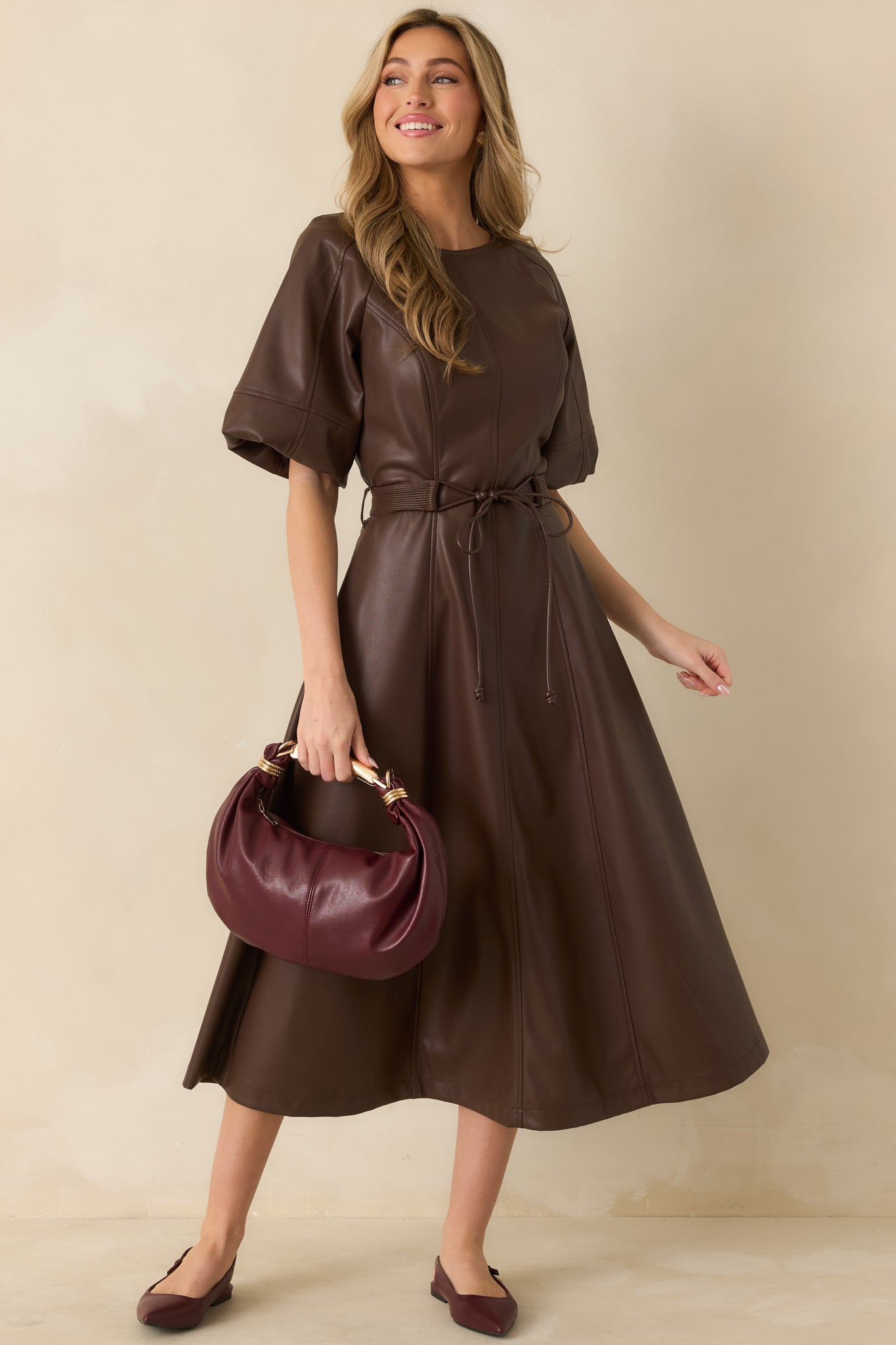 Slightly angled front view highlighting vertical seaming, soft sheen, and flowy silhouette of the midi dress.