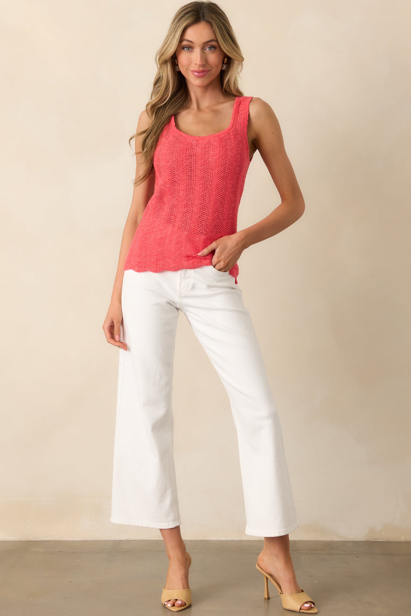 Full body view of this pink coral top with a scoop neckline, open knit texture, and scalloped hems.