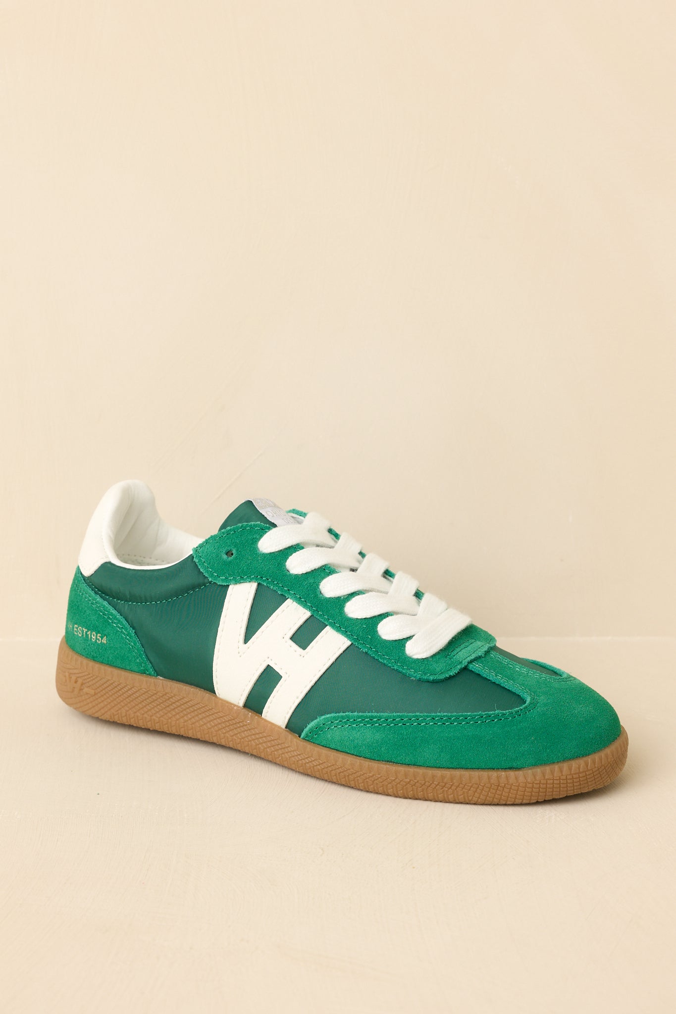 Angled view showcasing the lace-up design with standard white laces and textured multi-material upper construction.