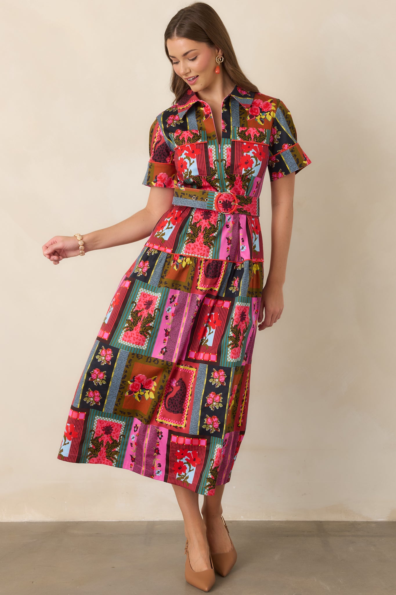 Vintage-inspired cotton-blend dress displaying its eclectic floral and stripe pattern, belted waist, short cuffed sleeves, and layered ankle-length skirt.