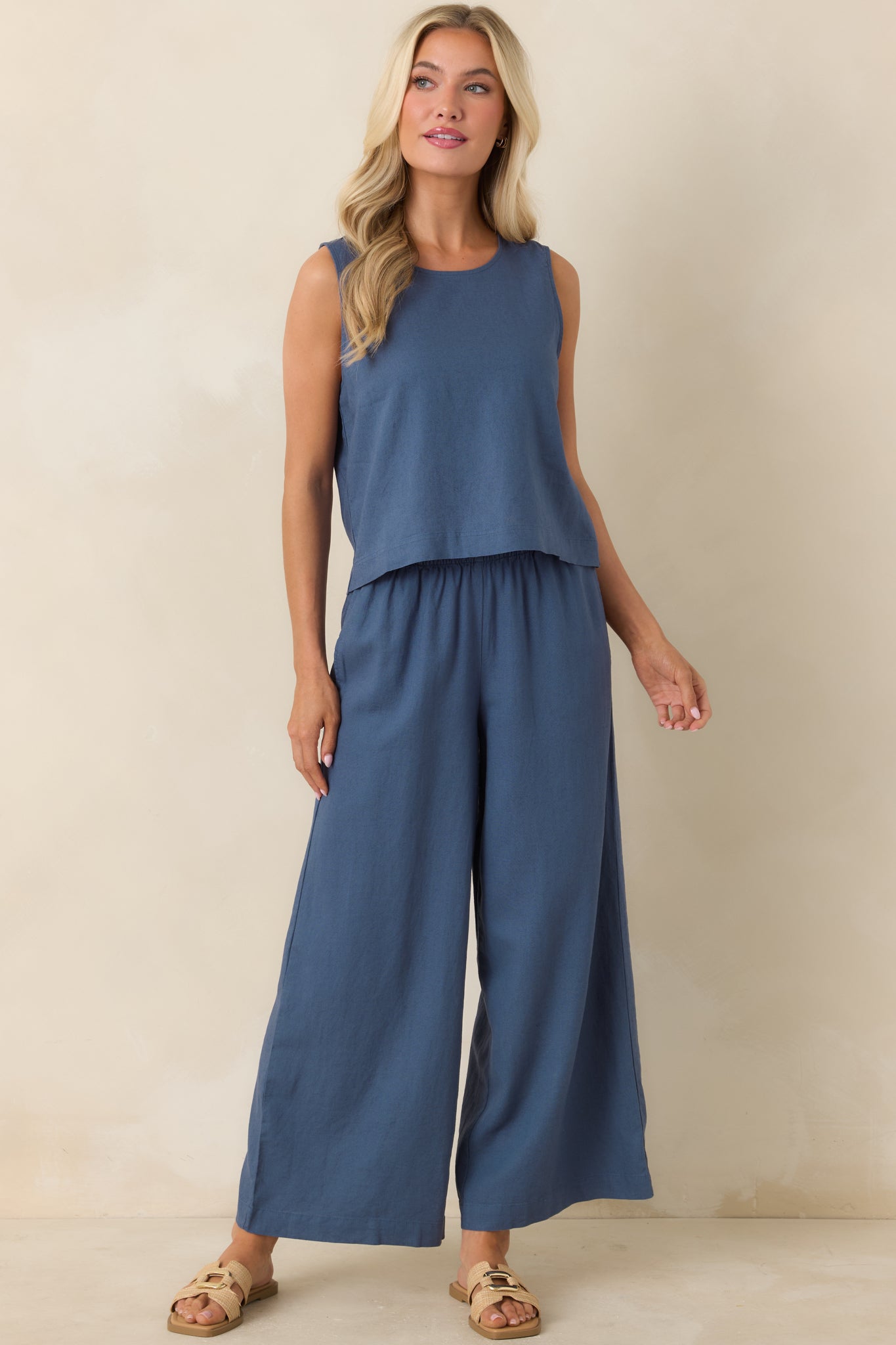 Vintage indigo wide-leg pants with high-rise fit, elastic waistband, and relaxed flowing silhouette.