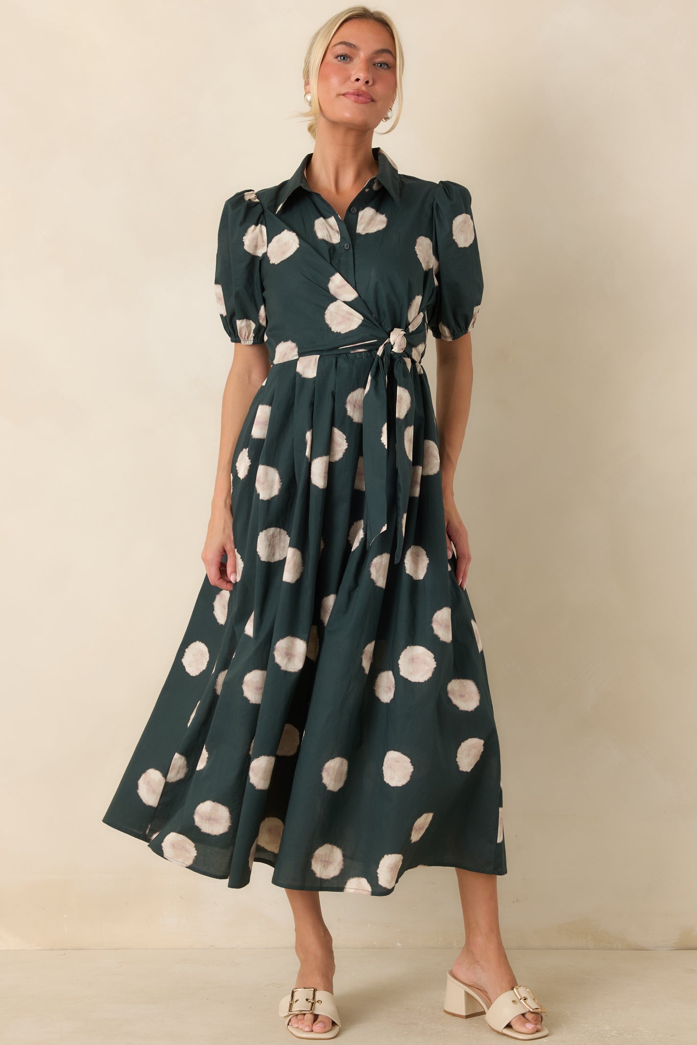 Vintage-inspired green dress designed with a collared neckline, button-front detailing, and a full midi-length skirt.