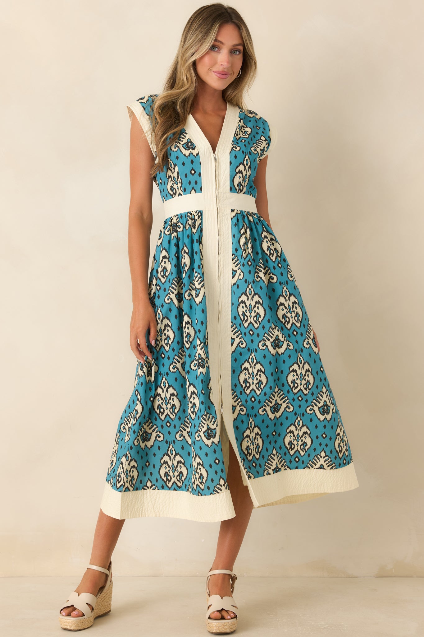 Vintage-inspired midi dress featuring a textured ivory border, breathable cotton fabric, cap sleeves, and flattering fitted waist.
