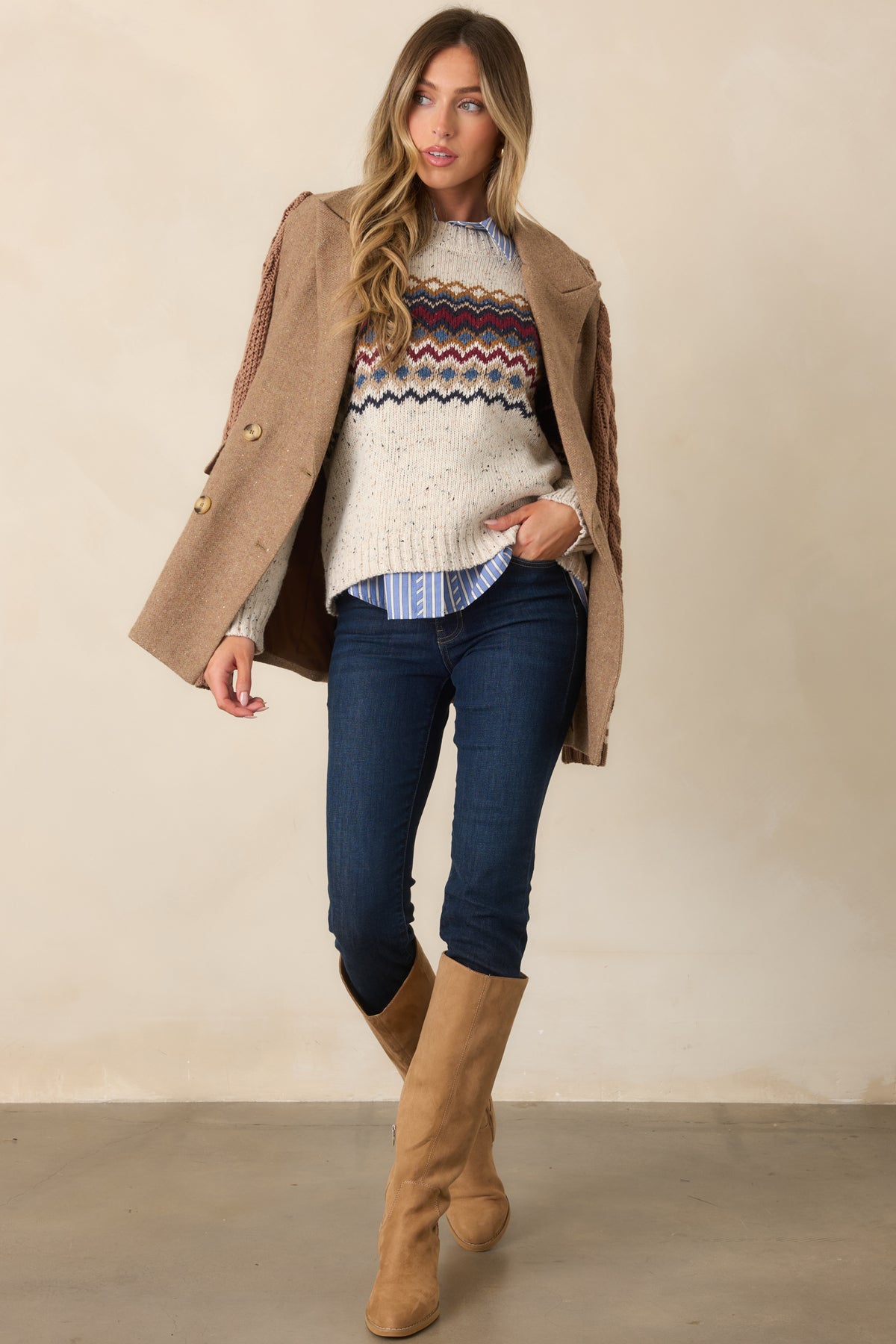 Vintage-inspired knit top featuring multicolor bands across the chest and sleeves, finished with a ribbed crew neckline, cuffs, and hem.