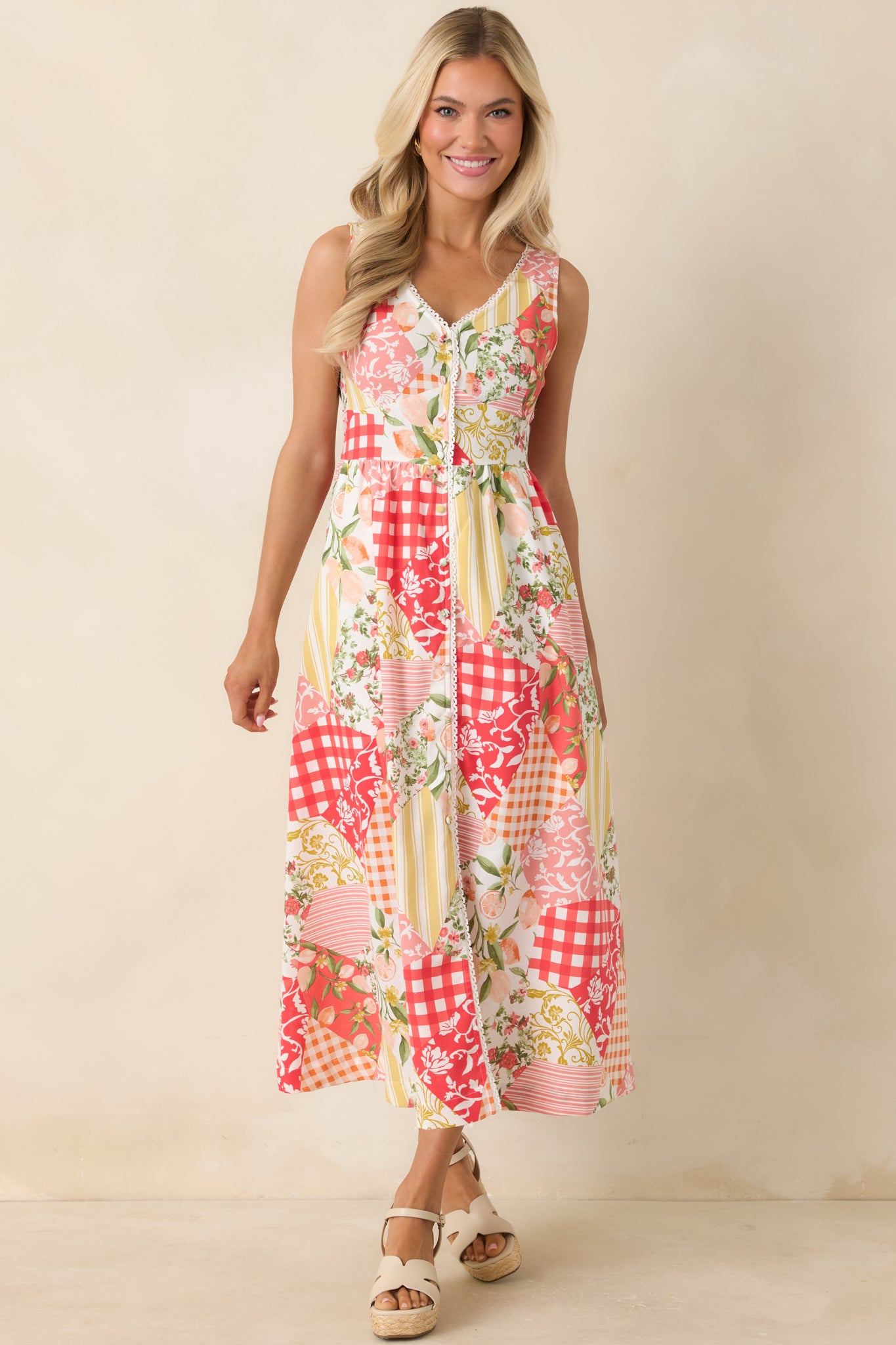 Vintage-inspired midi dress showcasing colorful patchwork patterns, a v-neckline with picot lace trim, and a flattering silhouette.