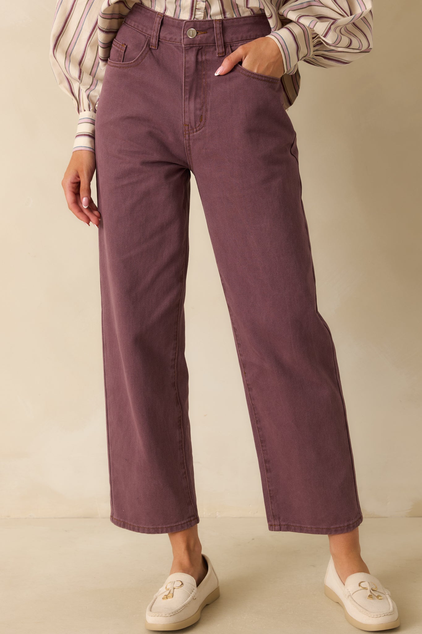 Violet high-rise jeans with a straight-leg silhouette, showing their structured cotton denim and classic fit.