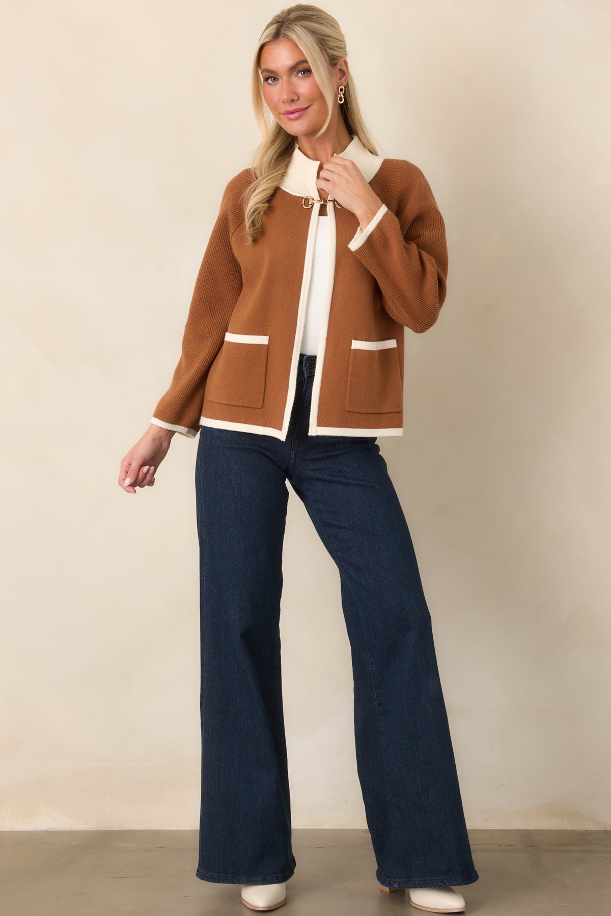 Soft viscose-blend cardigan featuring a relaxed silhouette, ribbed edges, and ivory contrast detailing.