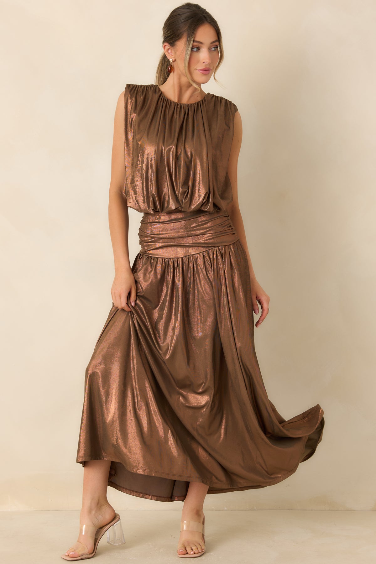 Warm bronze top featuring softly gathered shoulders, a relaxed draped body, and a voluminous cropped hem.