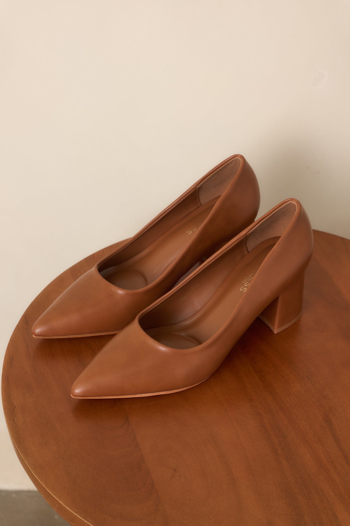 Warm camel heels with a smooth finish, pointed toes, and covered block heels.