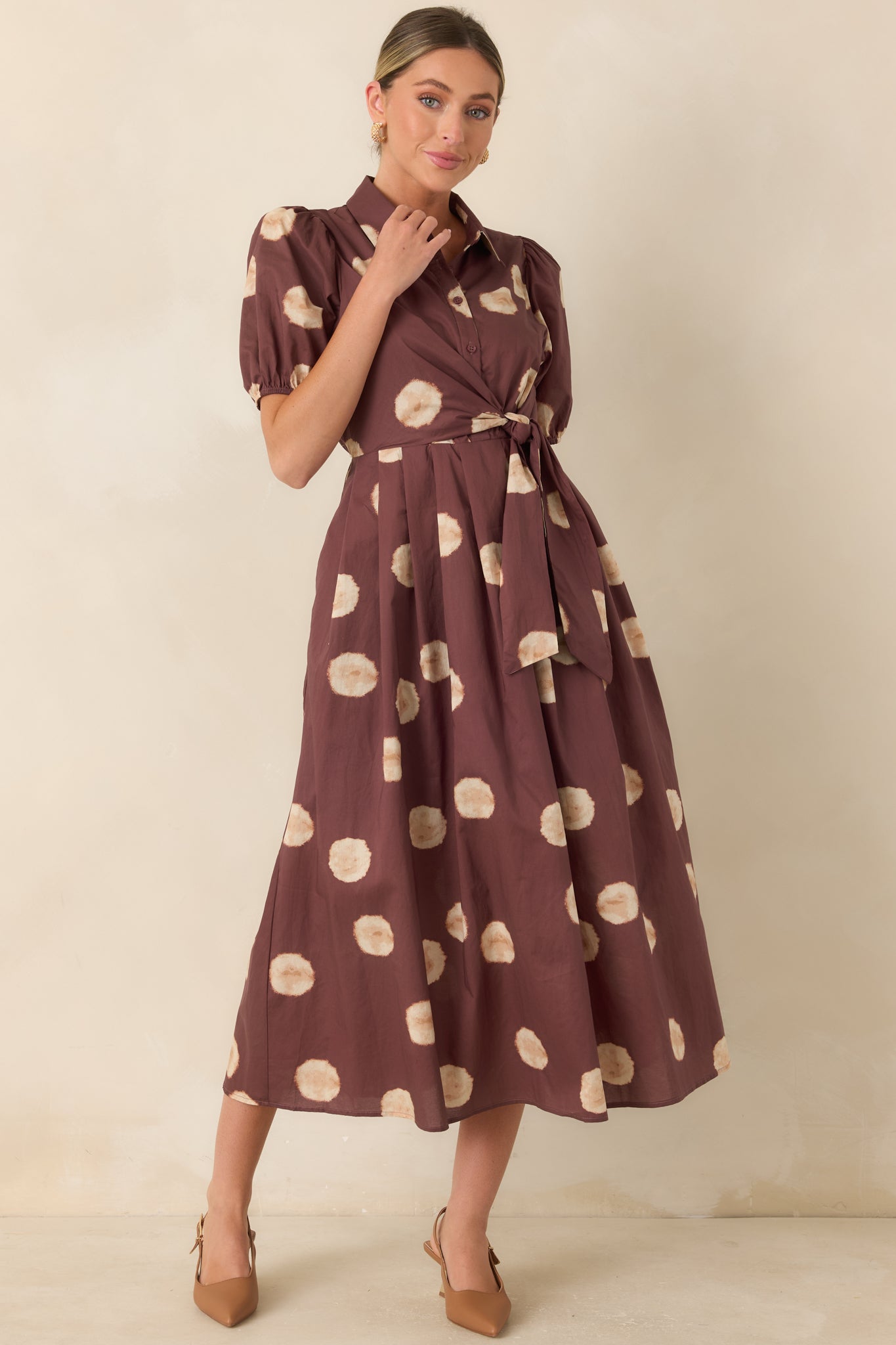 Warm-hued cotton midi dress designed with a wrap-inspired side tie, short puff sleeves, and an elastic back waistband for a flattering fit.