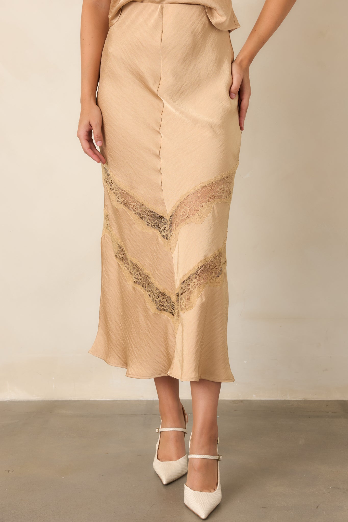 Warm tan skirt with an easy drape, smooth waist, and delicate lace contrast.
