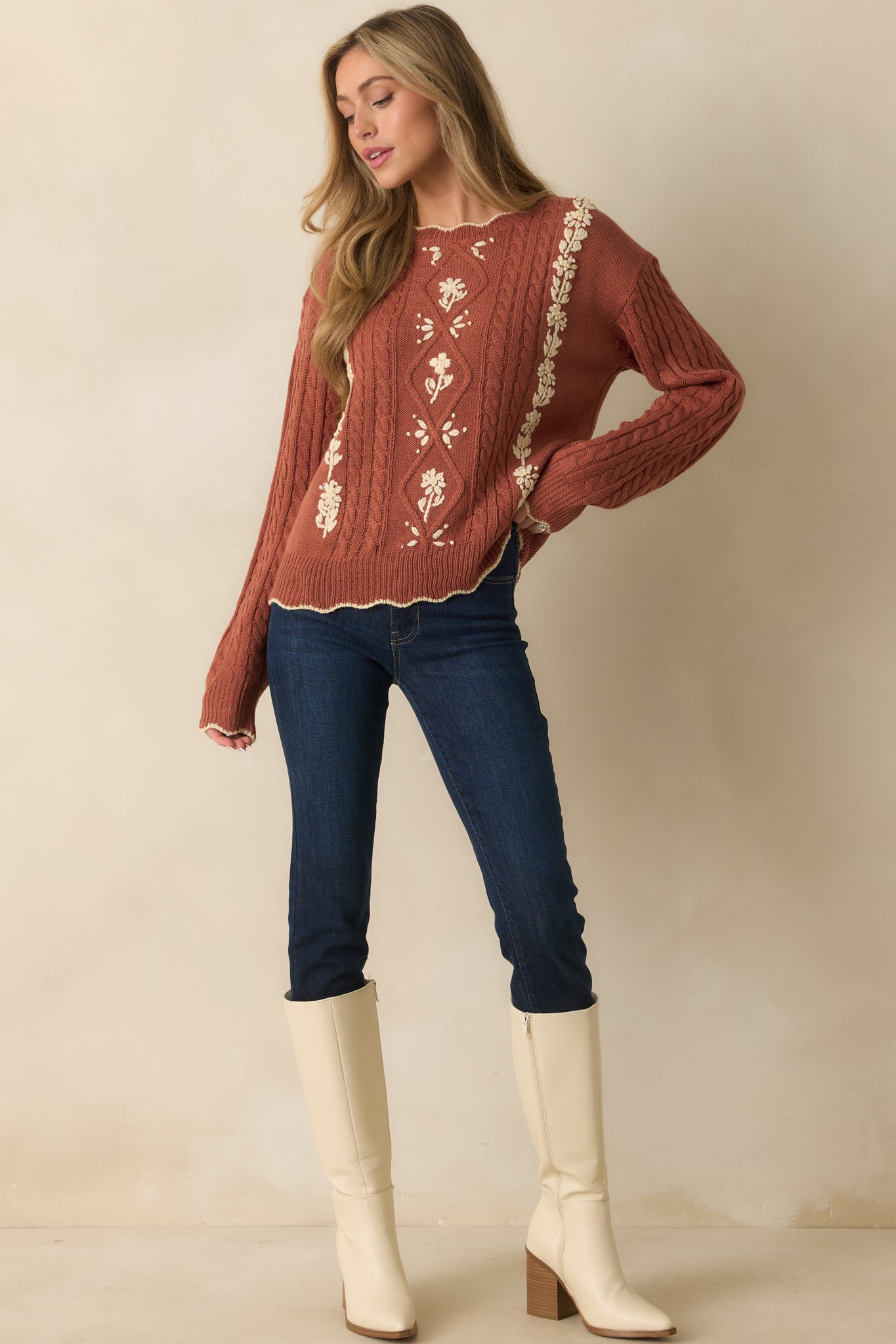 Warm-toned knit sweater with delicate ivory floral embroidery, crew neckline, and soft scalloped detailing.