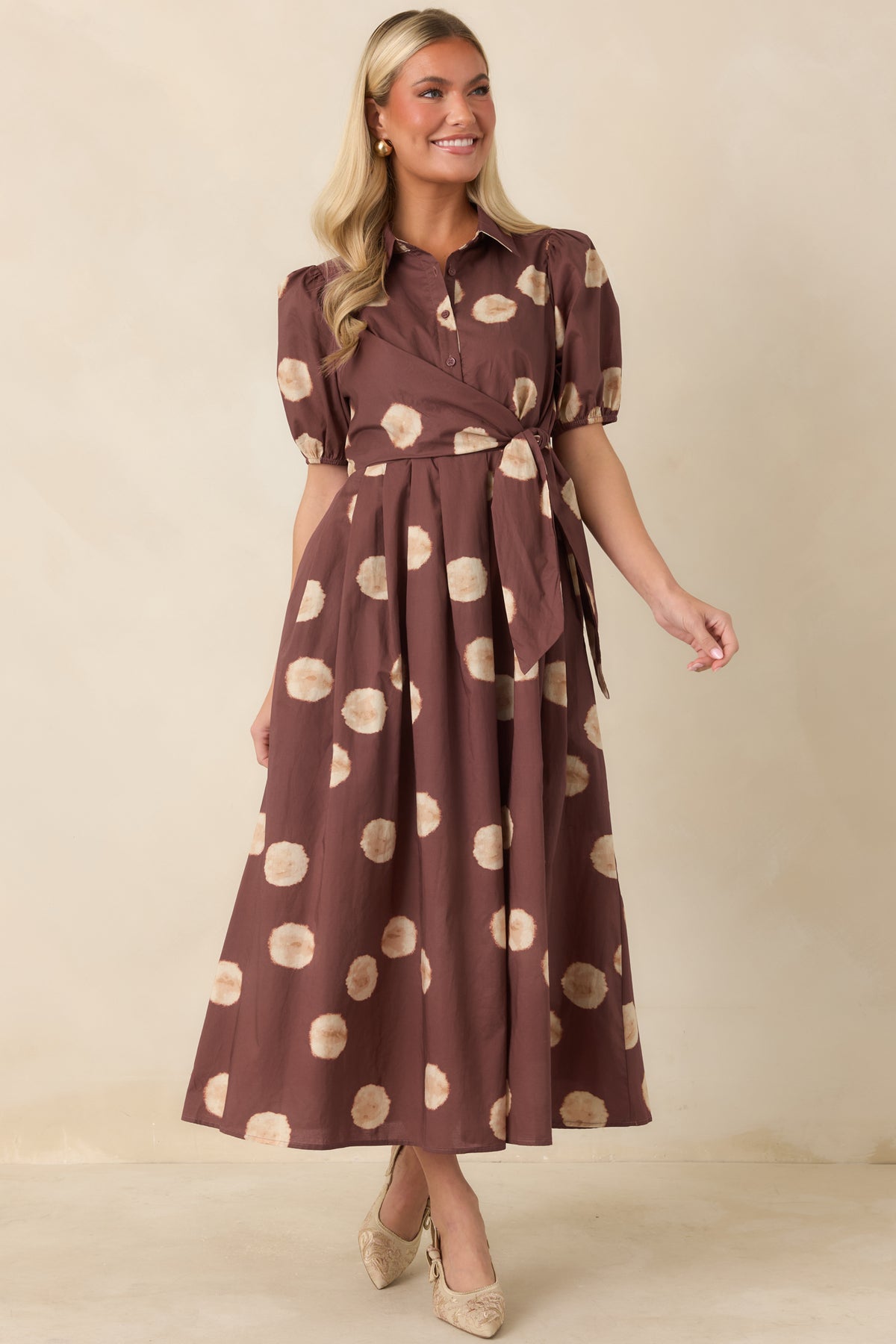 Warm-toned dress with elastic-cuff puff sleeves and a flowing A-line skirt.