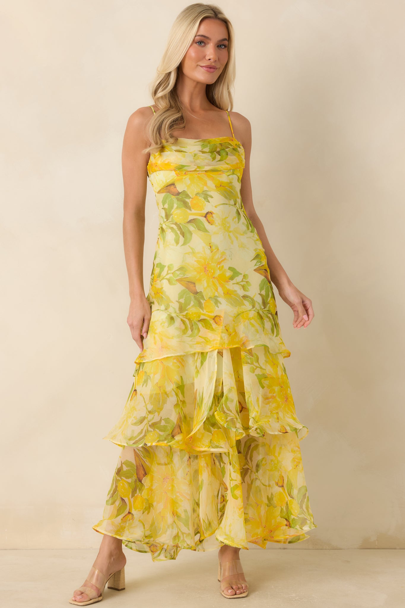 Watercolor-inspired floral dress highlighting a structured bodice, flowing silhouette, and dimensional tiered skirt.