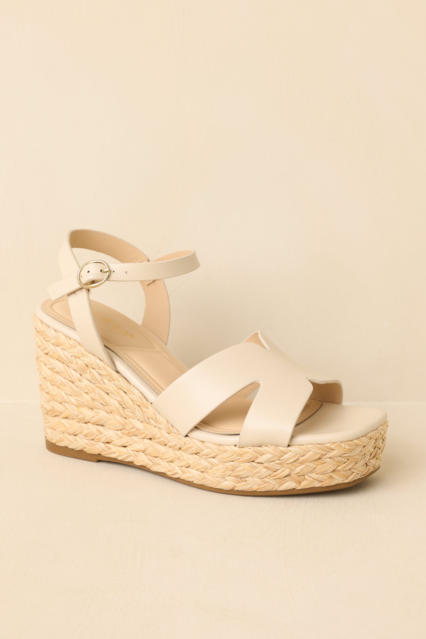 Wedge sandals shown in a three-quarter angle highlighting the shape of the espadrille heel and strap placement.