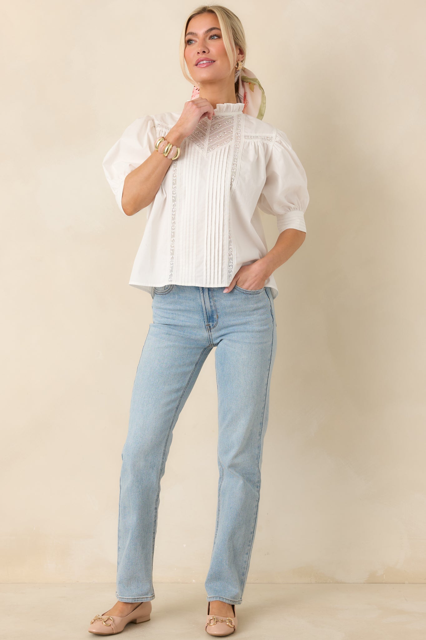 Front-facing full-length view of the white blouse showing the pintuck detailing and ruffled high neckline.