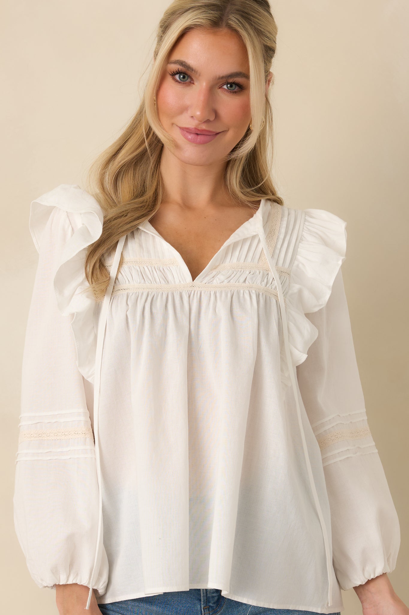 White blouse sleeve showcasing sheer fabric and elasticized cuff.