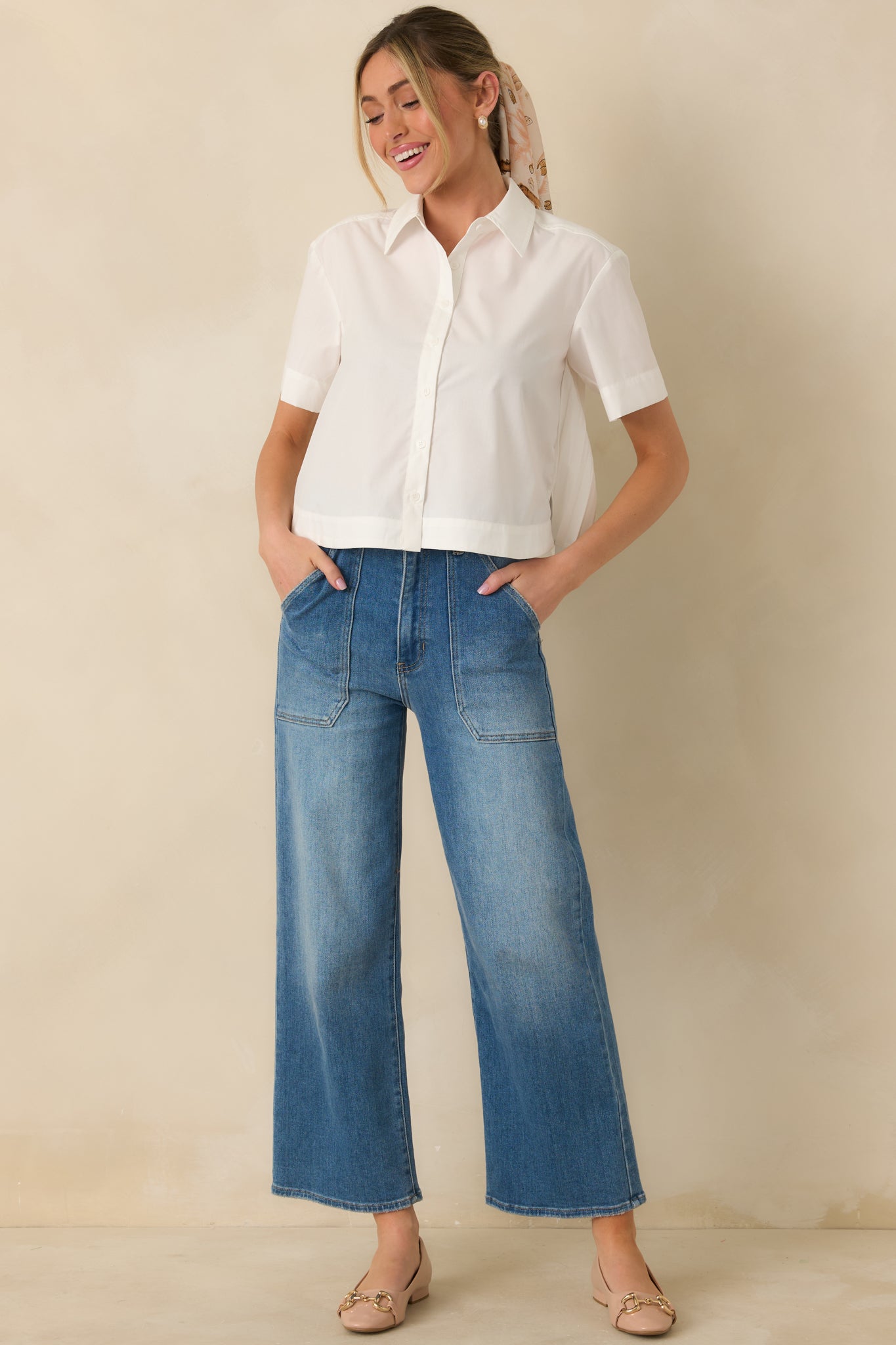 White woven button-up blouse with classic pointed collar, short sleeves, and straight hem.