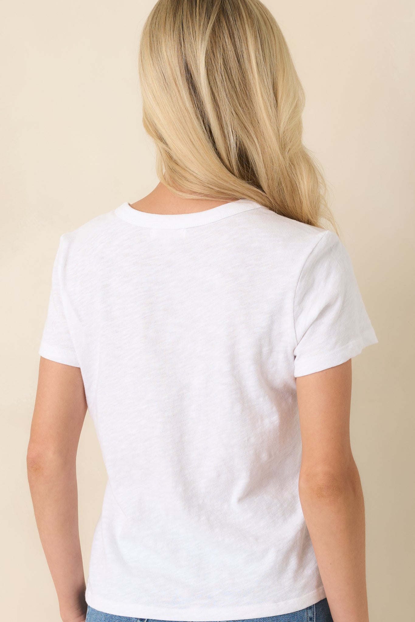 Back view of the white cotton tee featuring a relaxed fit and smooth slub knit texture.