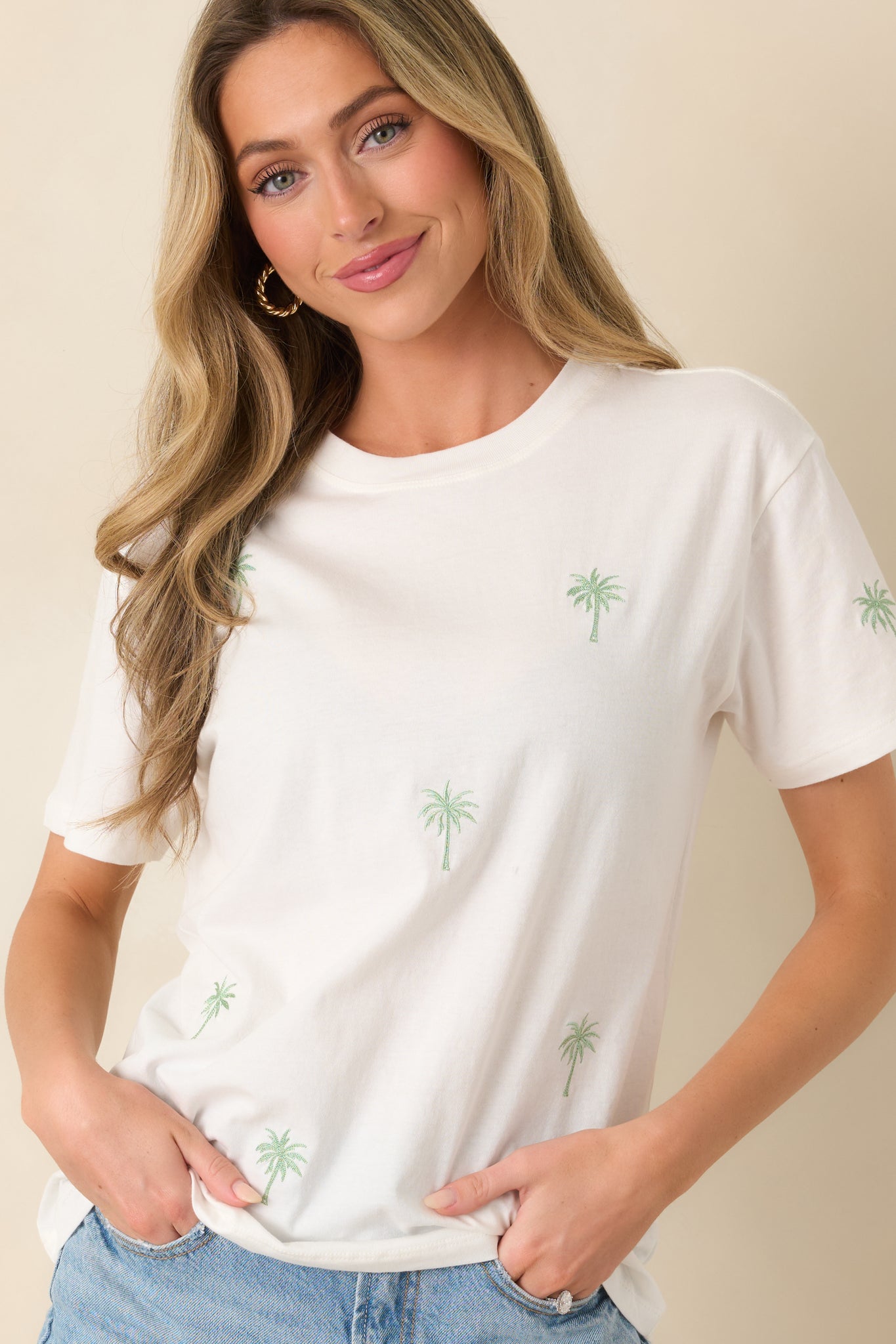 White cotton tee featuring palm tree detail work and a minimal, easy fit.