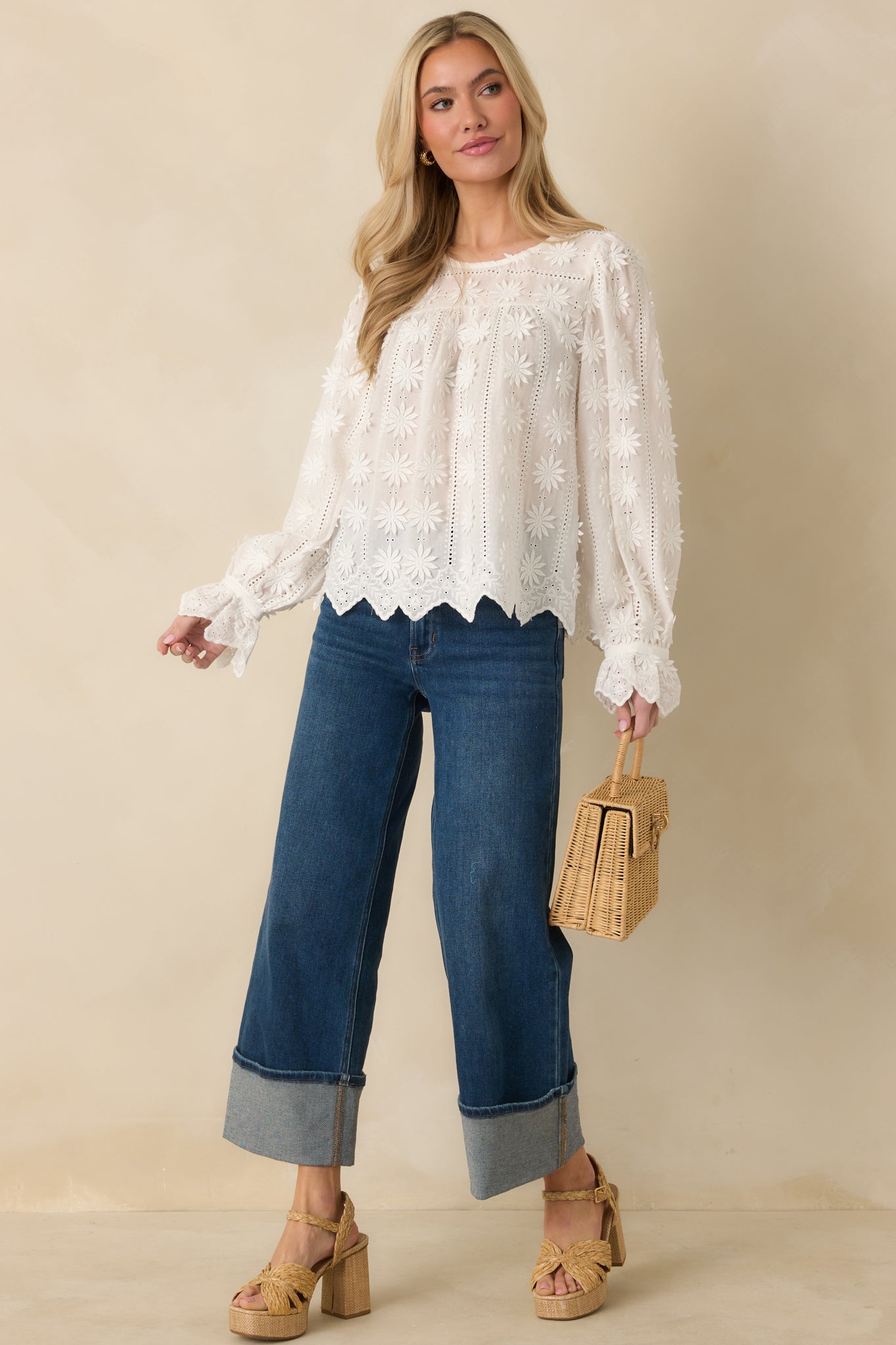 White long sleeve cotton top with a relaxed silhouette, rounded neckline, and raised floral appliqué adding soft texture throughout.