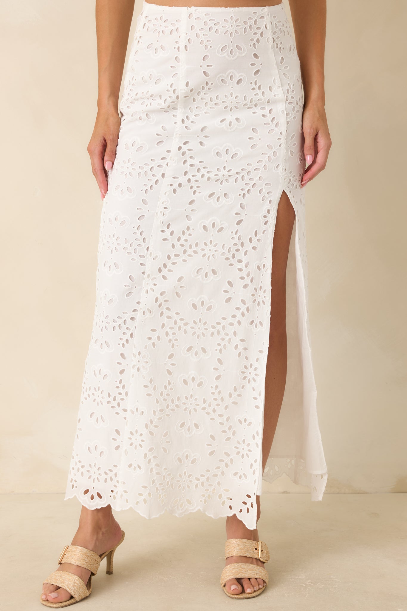 White embroidered skirt showcasing the scalloped hem detailing and fully lined construction for added coverage.