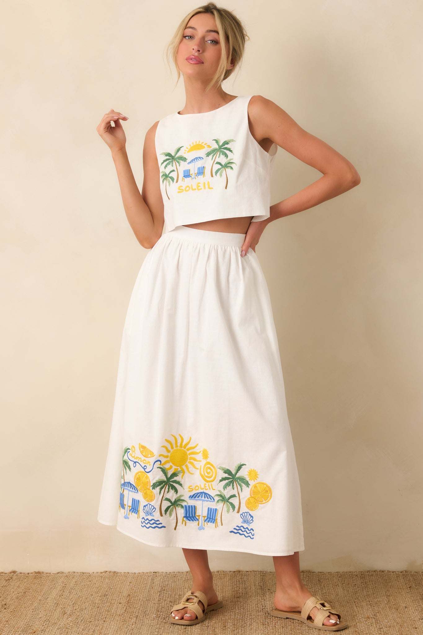 White embroidered top with palm tree and seaside motifs and cropped silhouette.
