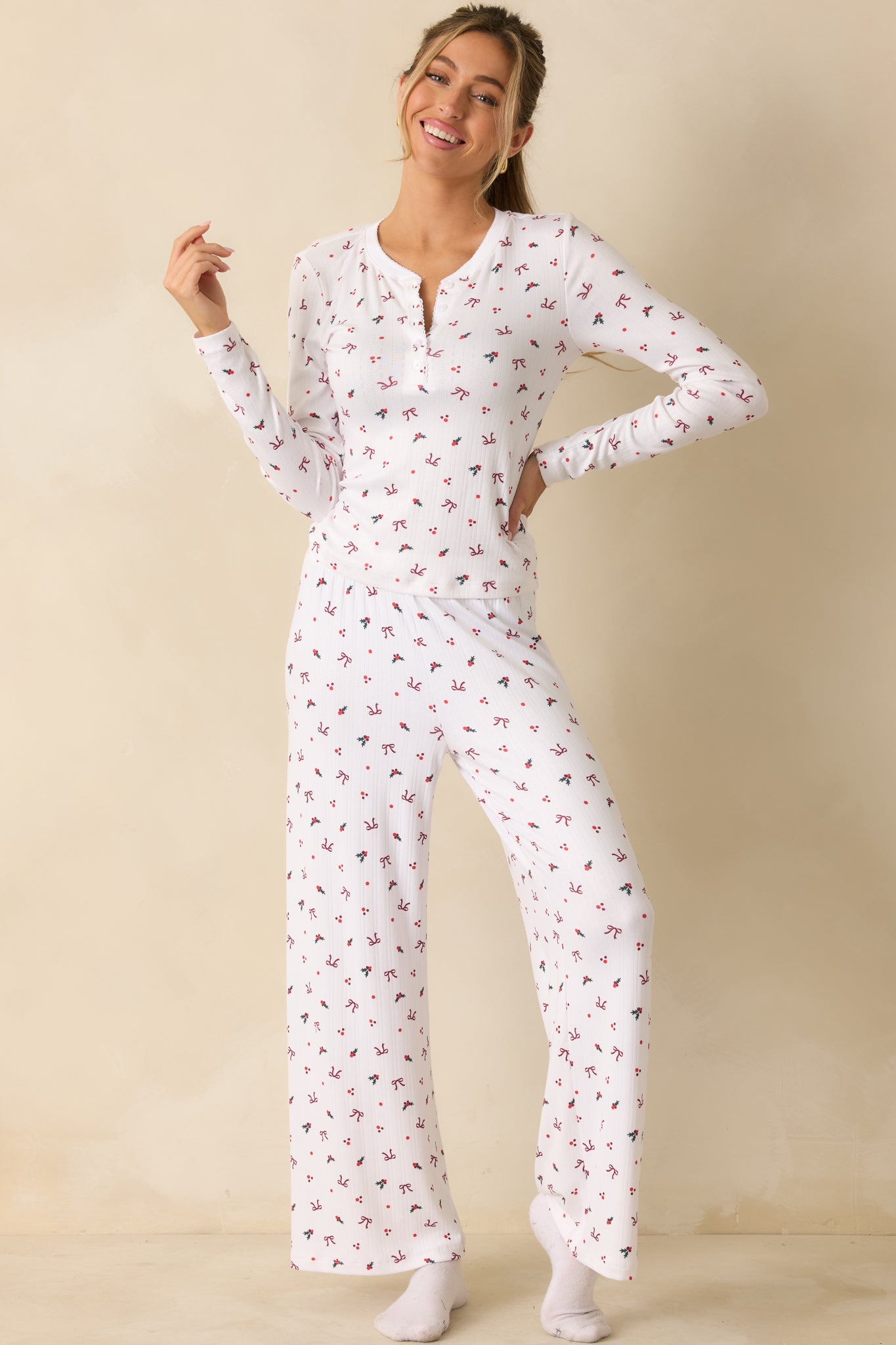 White fitted henley top with soft-wash texture, showcasing the full-sleeve design and allover holiday pattern.