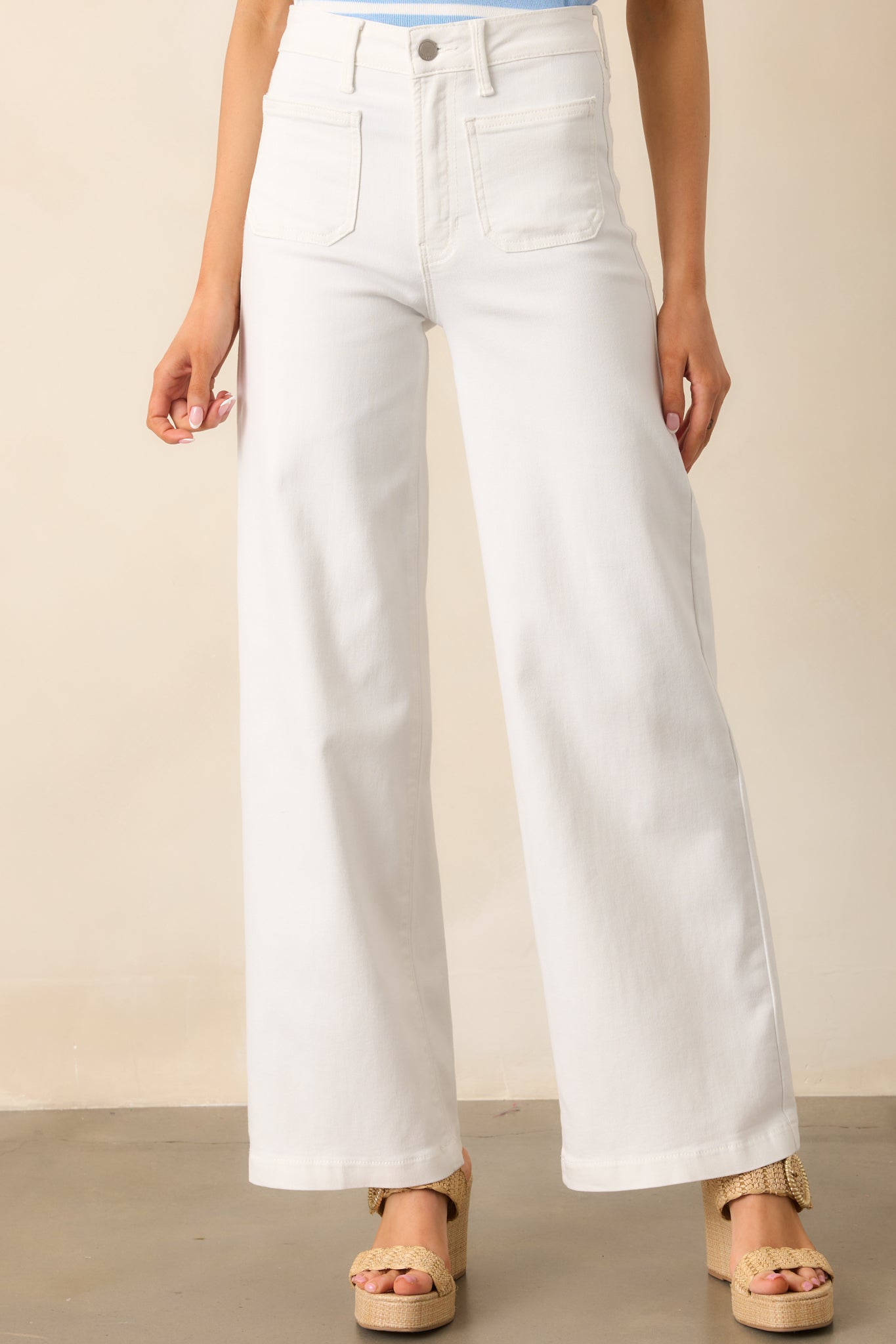 White jeans with a high-rise waist, straight-leg design, and functional front and back pockets for a sleek, classic look.