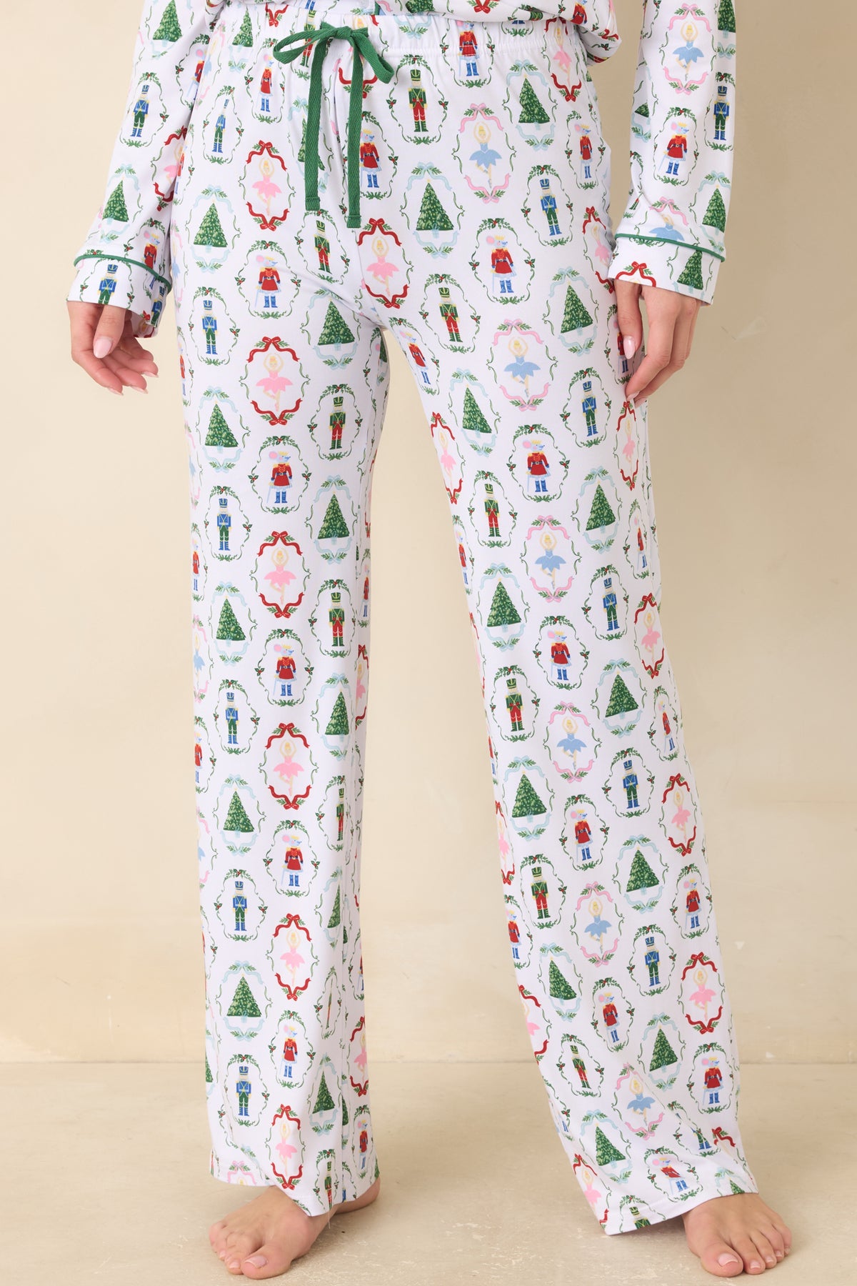 White pajama pants feature an adjustable drawstring waistband above the festive allover print.