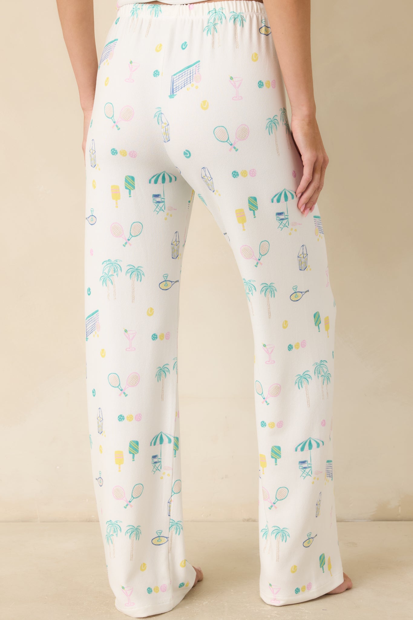 Back view of the white pajama pants highlighting the relaxed wide-leg silhouette, elastic waistband, and lightweight knit construction.