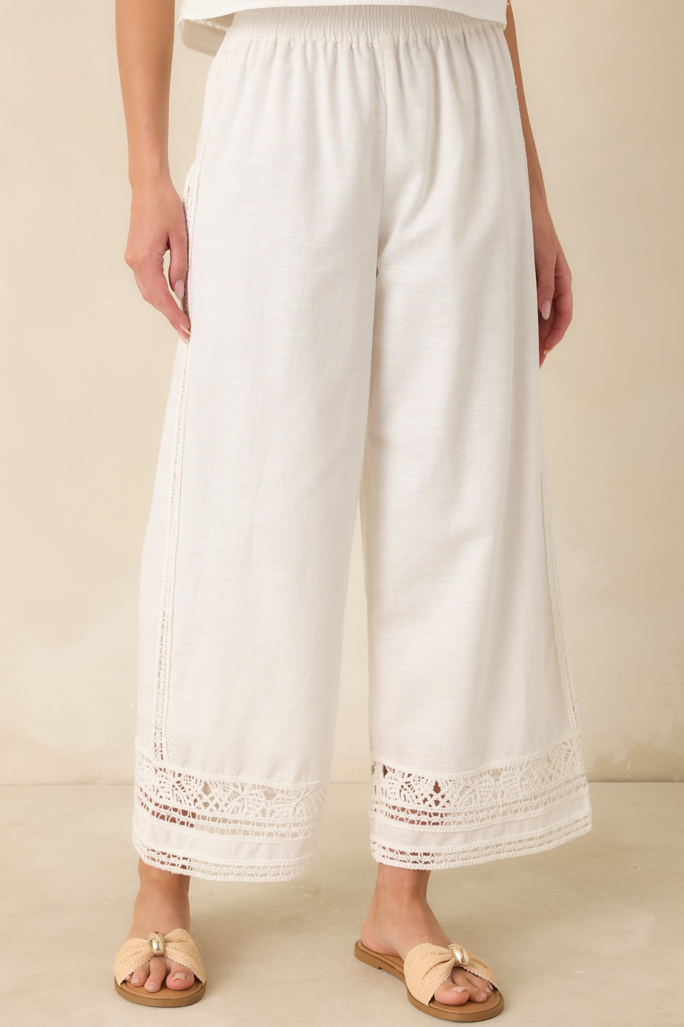 White pants featuring side pockets and breathable cotton-linen texture in a relaxed drape.