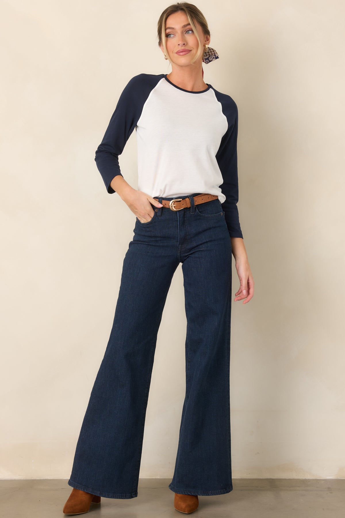 White raglan top featuring navy sleeves and matching neckline trim in a relaxed silhouette.