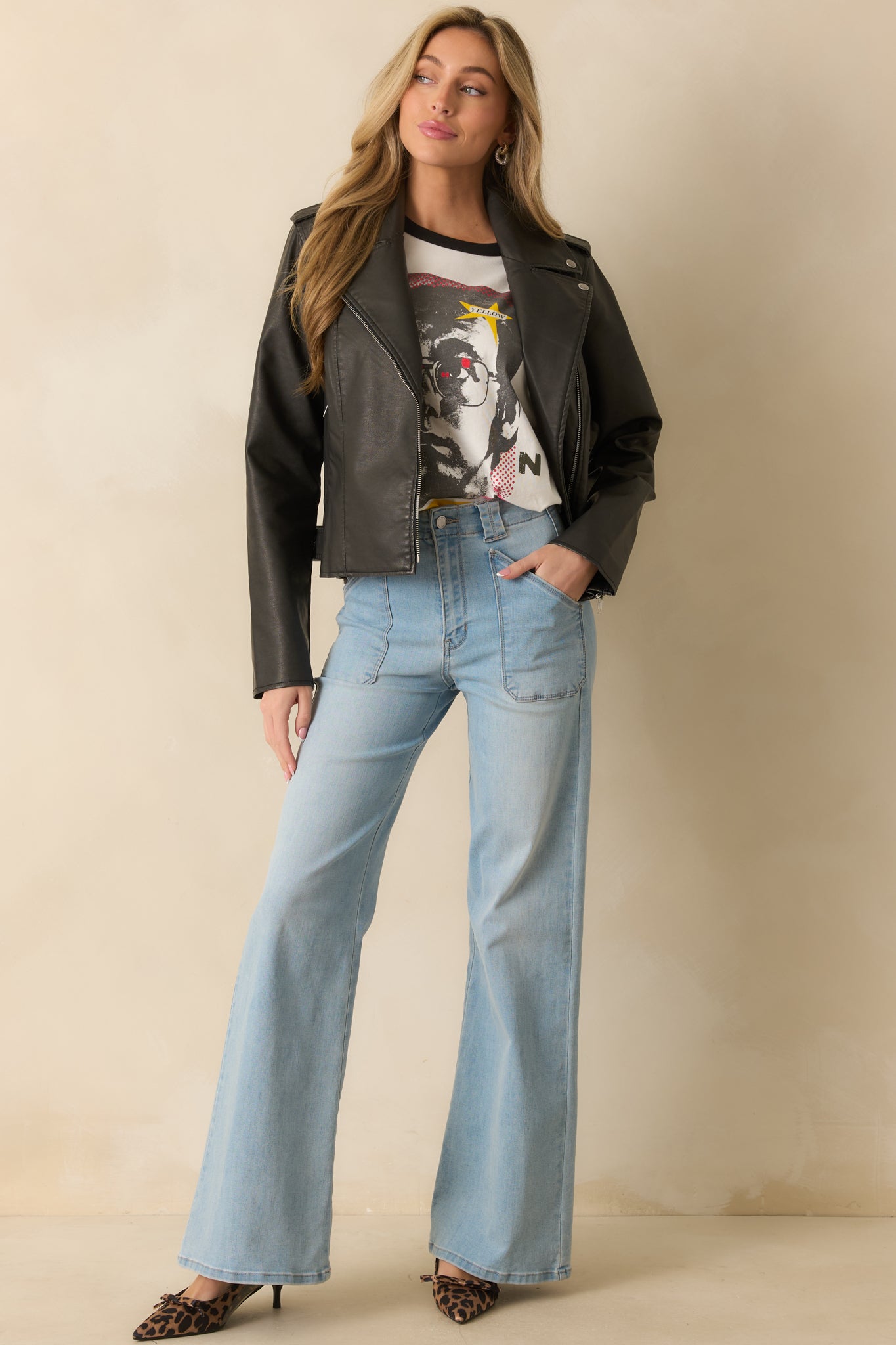 White tee with black neckline and sleeve trim, showcasing bold multicolor Elton John tour design.