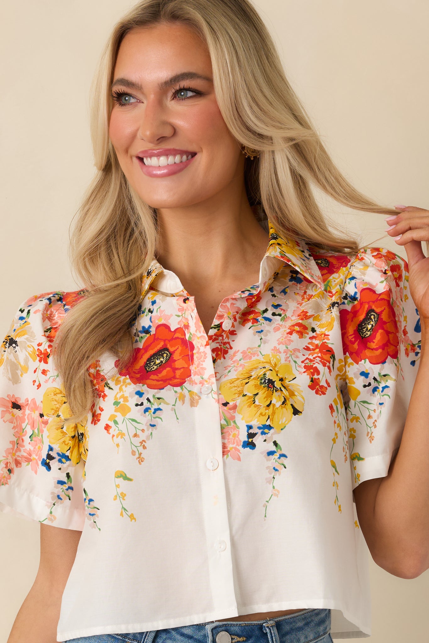 White short sleeve top showing the structured collar and smooth button placket.