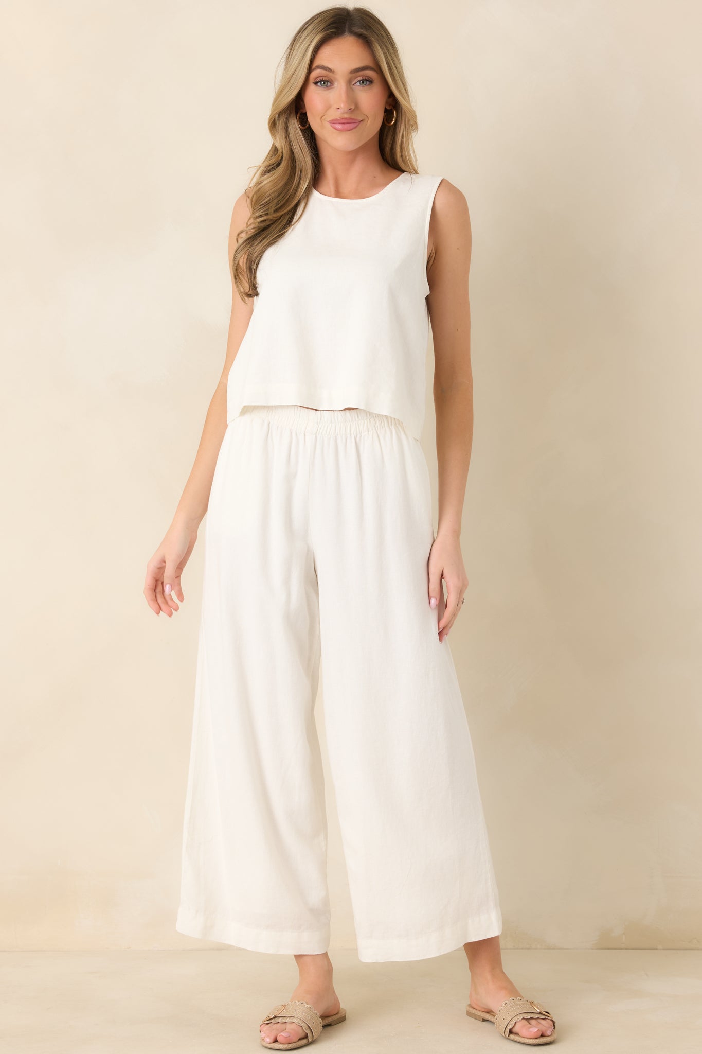 White sleeveless tank with a classic round neckline, relaxed straight silhouette, and lightweight linen-blend fabric for an airy, breathable fit.