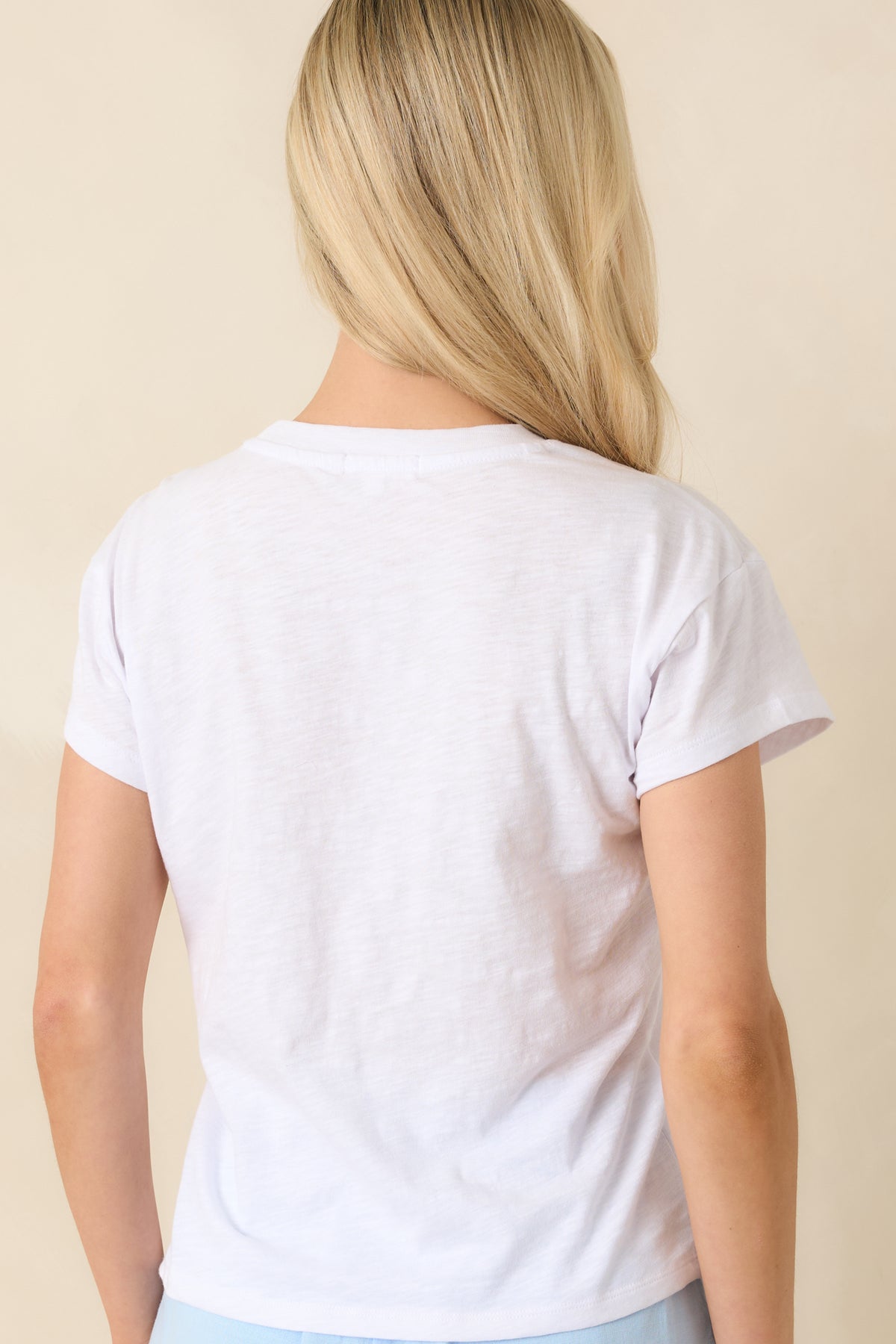 Rear view of the white slub tee featuring short sleeves, lightweight jersey fabric, and a modern fit.