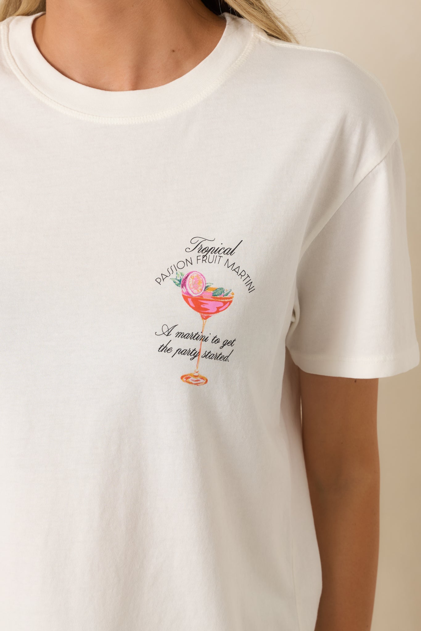 Close-up of the white tee highlighting the front chest graphic, cotton texture, and classic crew neckline.