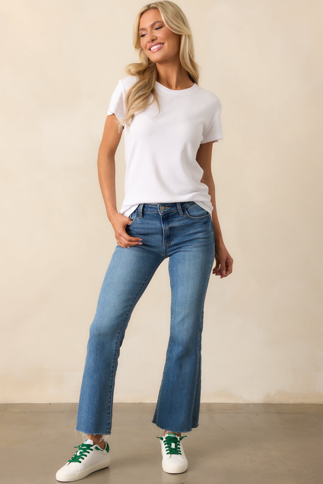 Full body view of white tee featuring a ribbed crew neckline, short sleeves, and a slightly relaxed silhouette.